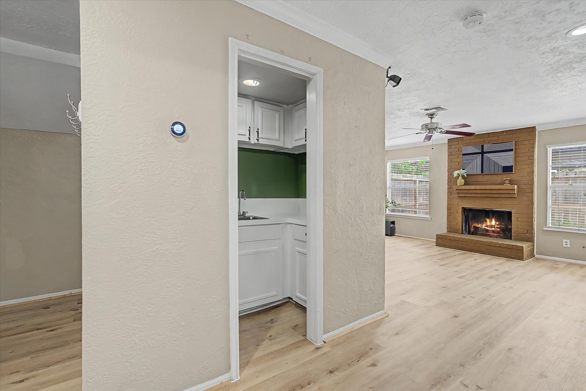 Wide angled view of the hallway leading to the living room.