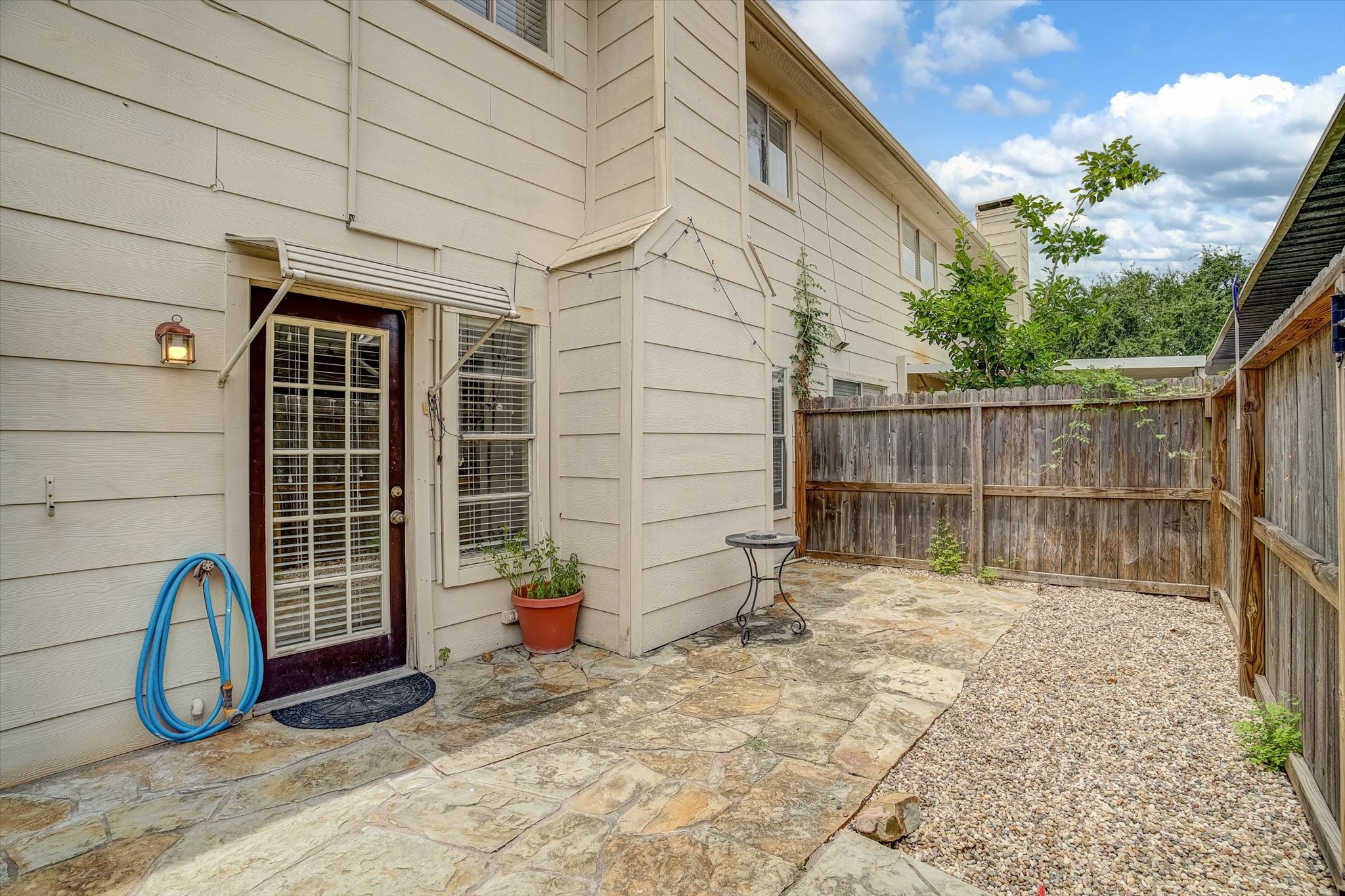 Exterior patio with access to the house as well as carport.