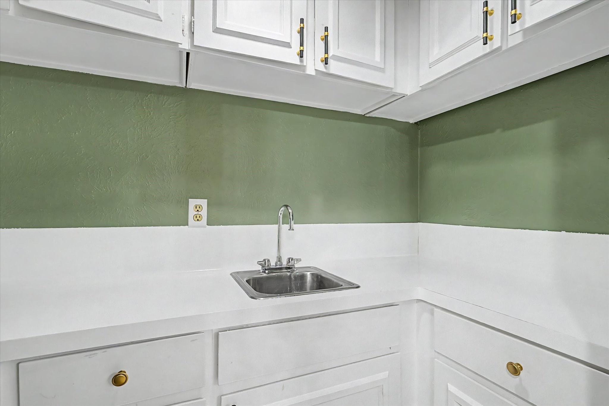 Built-in cabinetry with countertop, sink, and ample storage.
