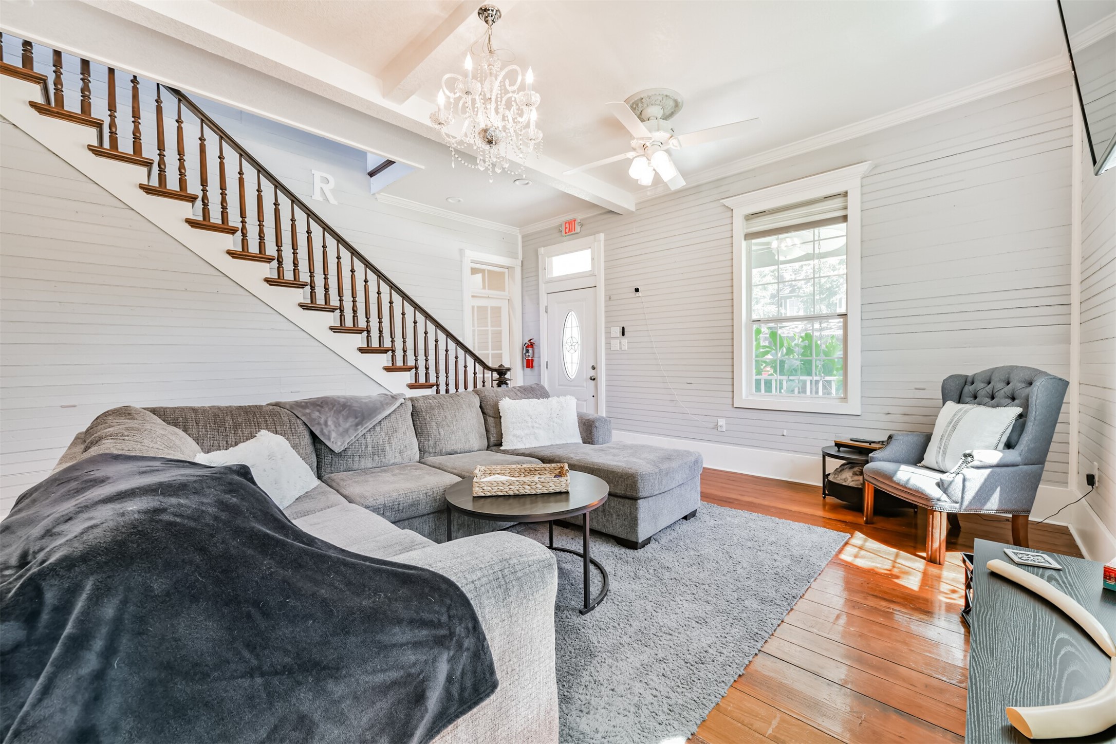 The original dark walnut staircase is a stunning centerpiece and piece of the homes 1890 craftsmanship.