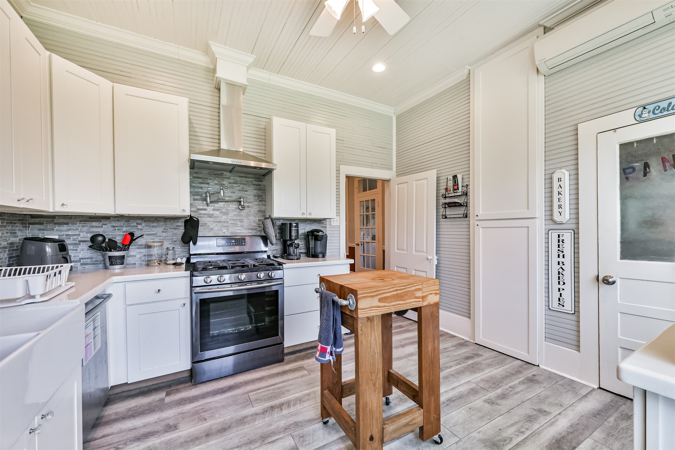 Updated kitchen offers abundant cabinetry and convenient access to the adjoining living spaces.