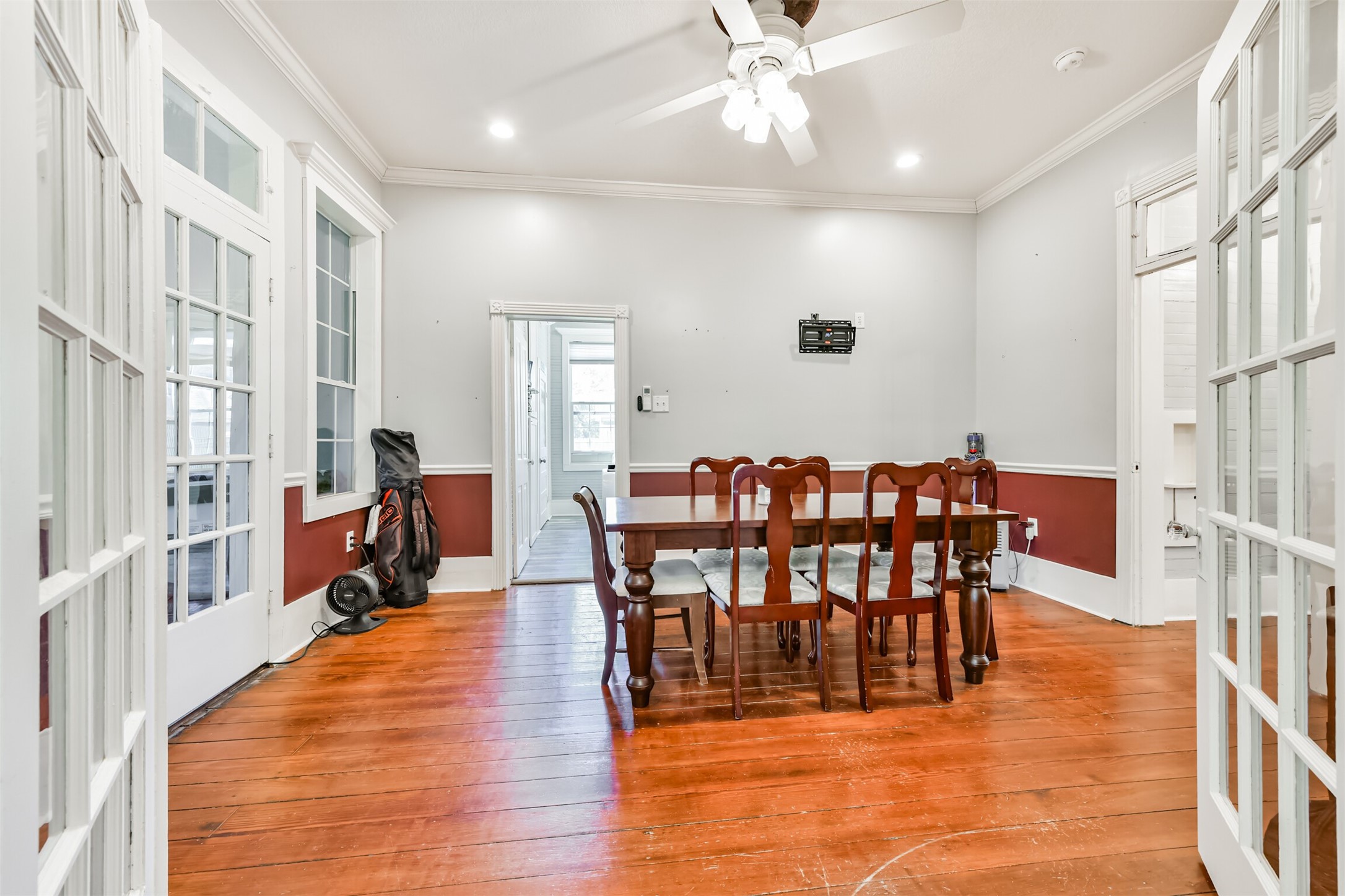 Flexible dining or gathering space showcases original hardwood flooring and beautiful natural light.