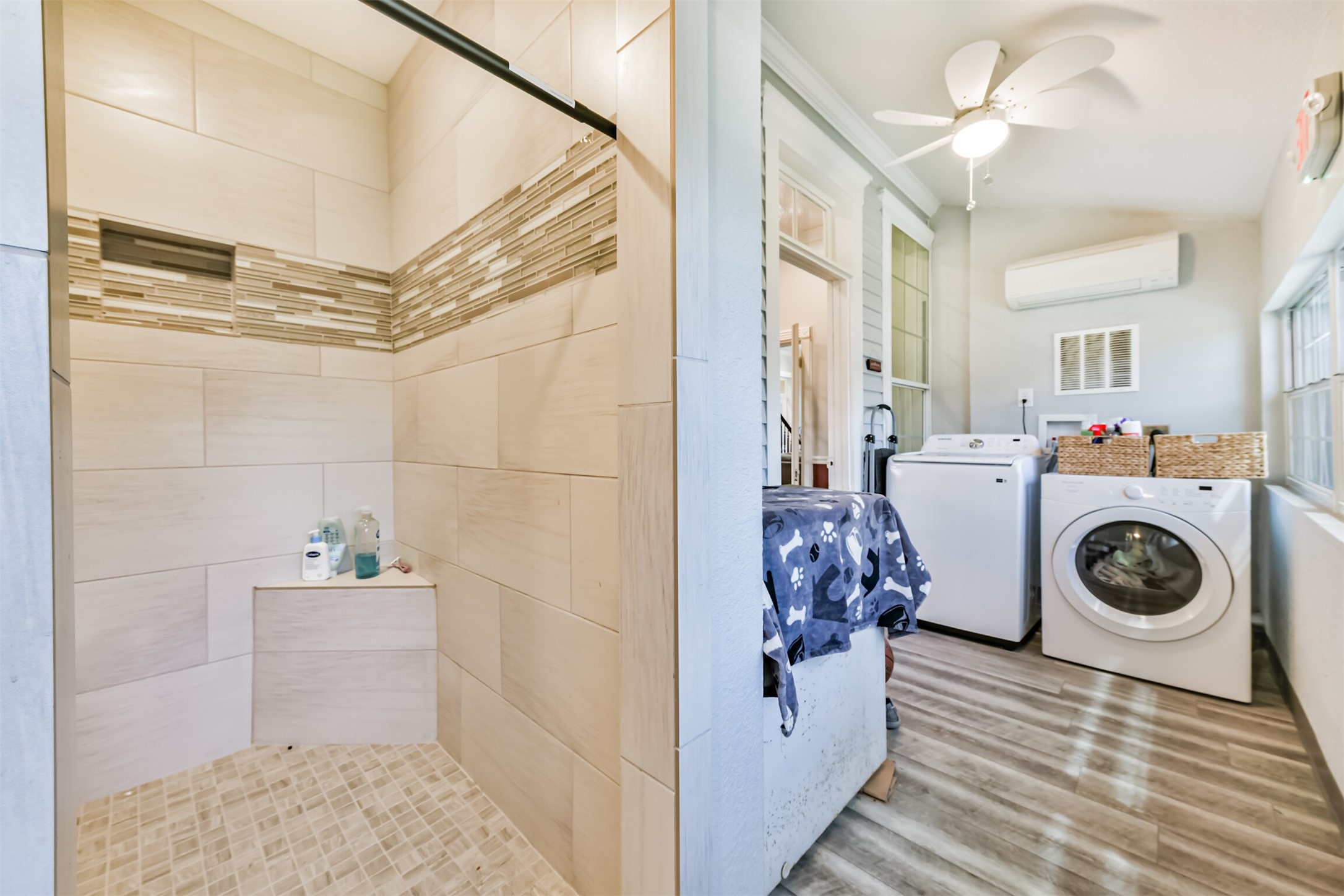 Convenient utility area with laundry, storage and shower.