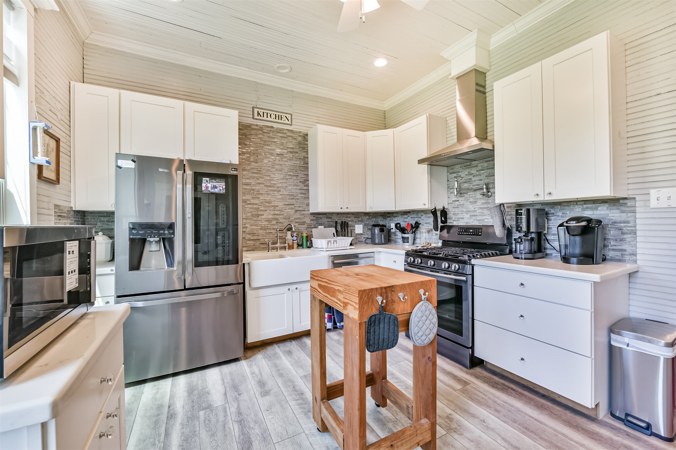 Bright kitchen features updated cabinetry, stainless appliances and plenty of workspace.