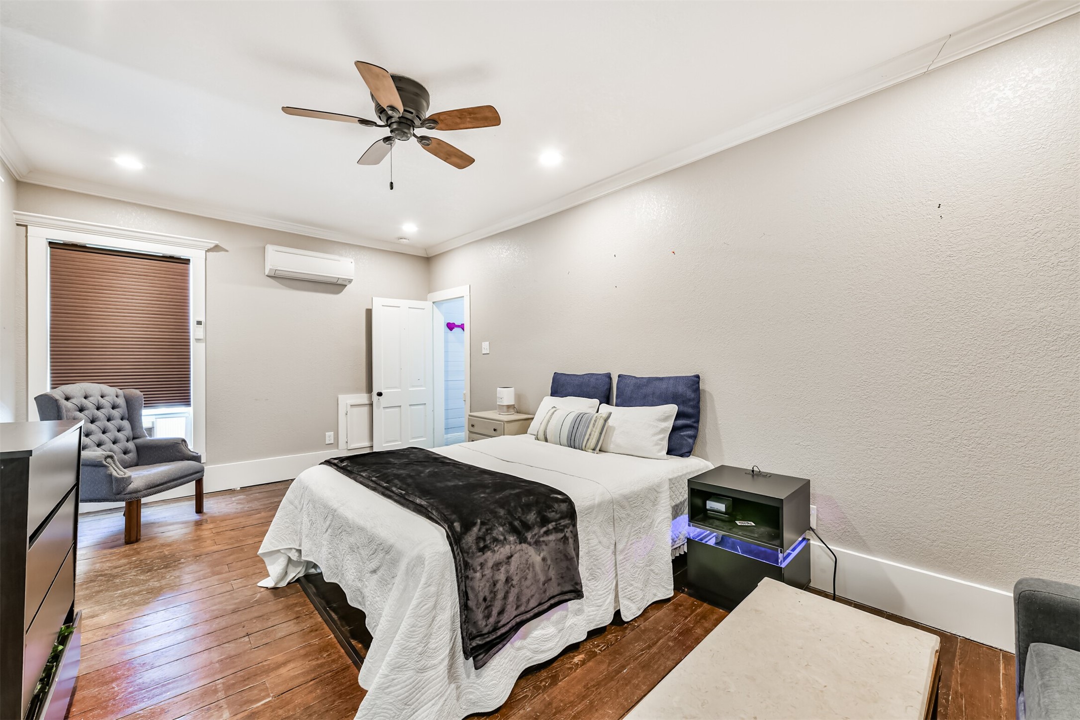 Bright, spacious bedroom offers plenty of room for a sitting area or additional workspace.
