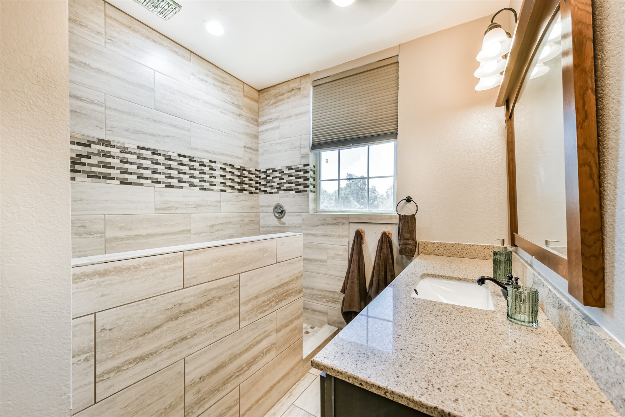 Beautifully remodeled full bath pairs modern finishes with details that complement this historic home.