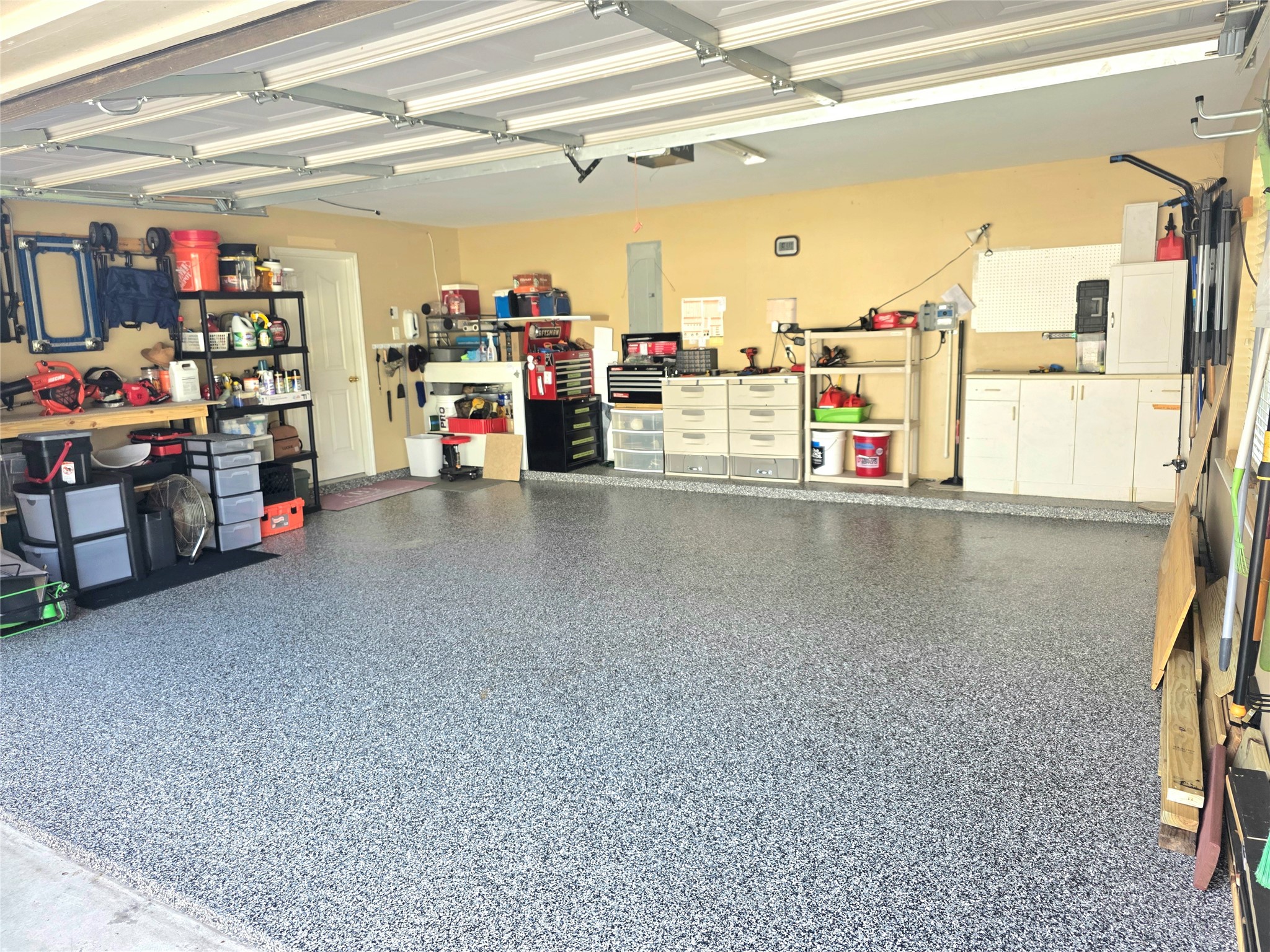 Spacious garage with the nice epoxy coating on the floor