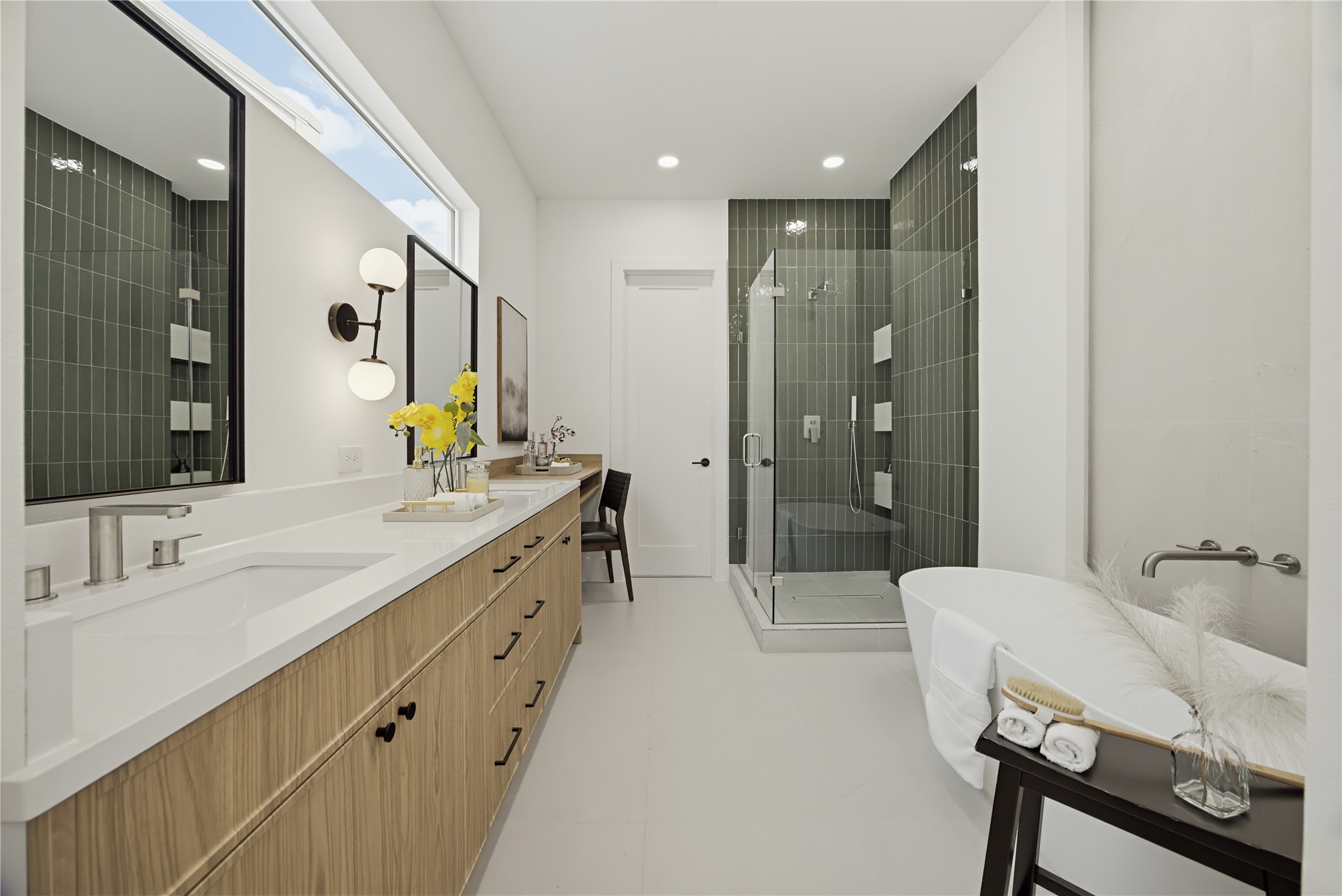 Luxurious bathroom featuring a sleek double vanity with ample storage, a modern glass-enclosed shower, and a freestanding soaking tub for ultimate relaxation.