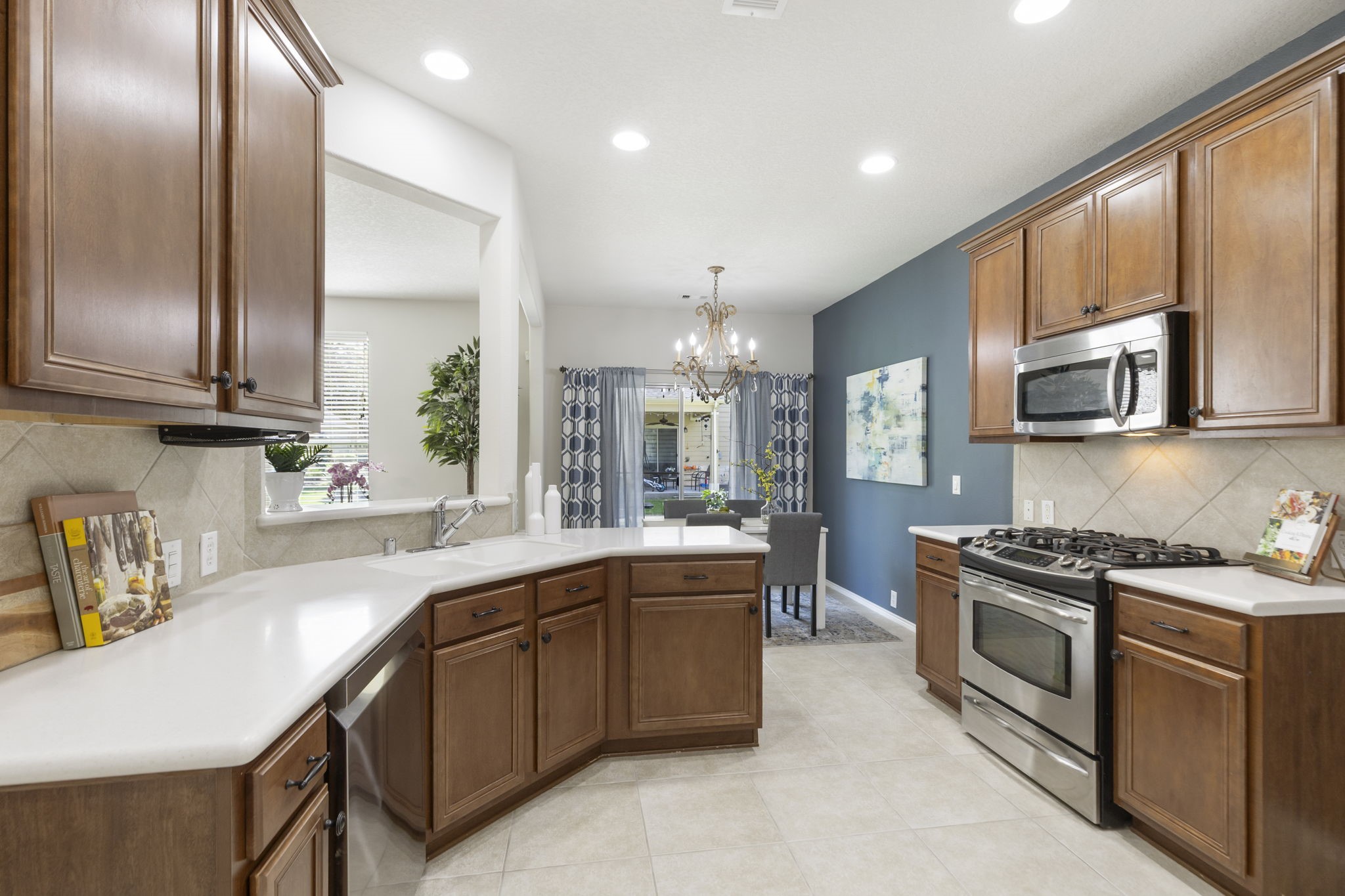 The kitchen includes natural wood cabinetry with a rich finish, abundant storage and a large 5 foot deep walk-in pantry!