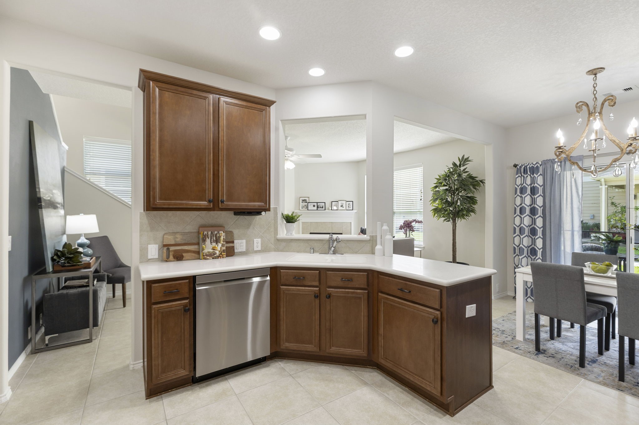This view highlights the easy flow between the kitchen, dining and living areas. The beautiful blue accent wall (seen at the left) would be ideal as a sitting / reading area, a drop zone or a holiday buffet / bar area.