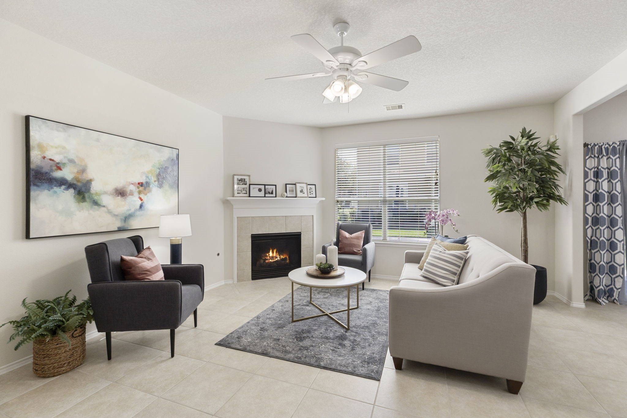 Bright and inviting living room with a corner gas log fireplace, fresh neutral paint, and abundant natural light.