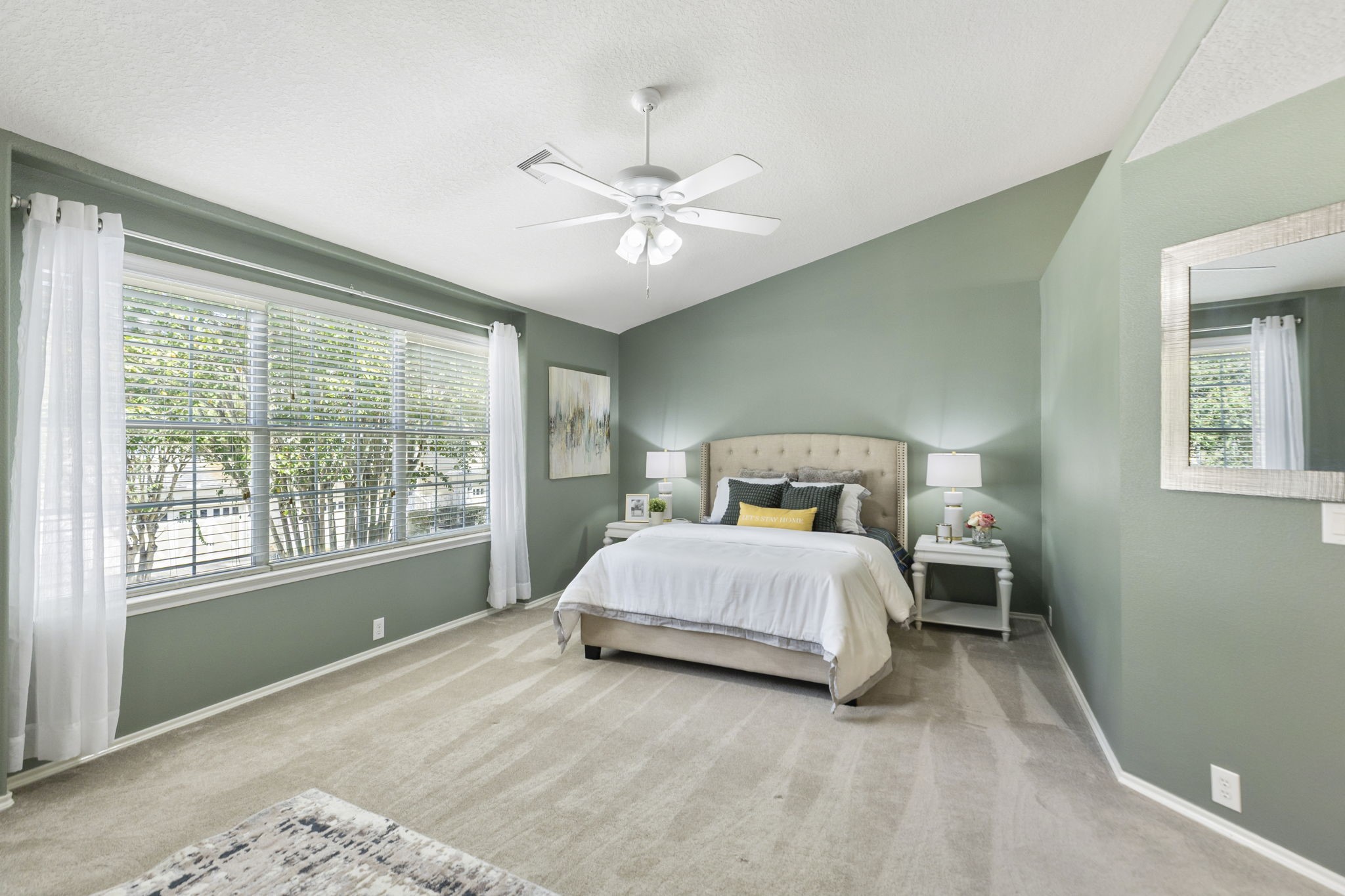 Where do I begin? This primary bedroom has everything you would ever want; vaulted ceiling, tree-top views, ceiling fan, soft carpeting and abundant natural light.