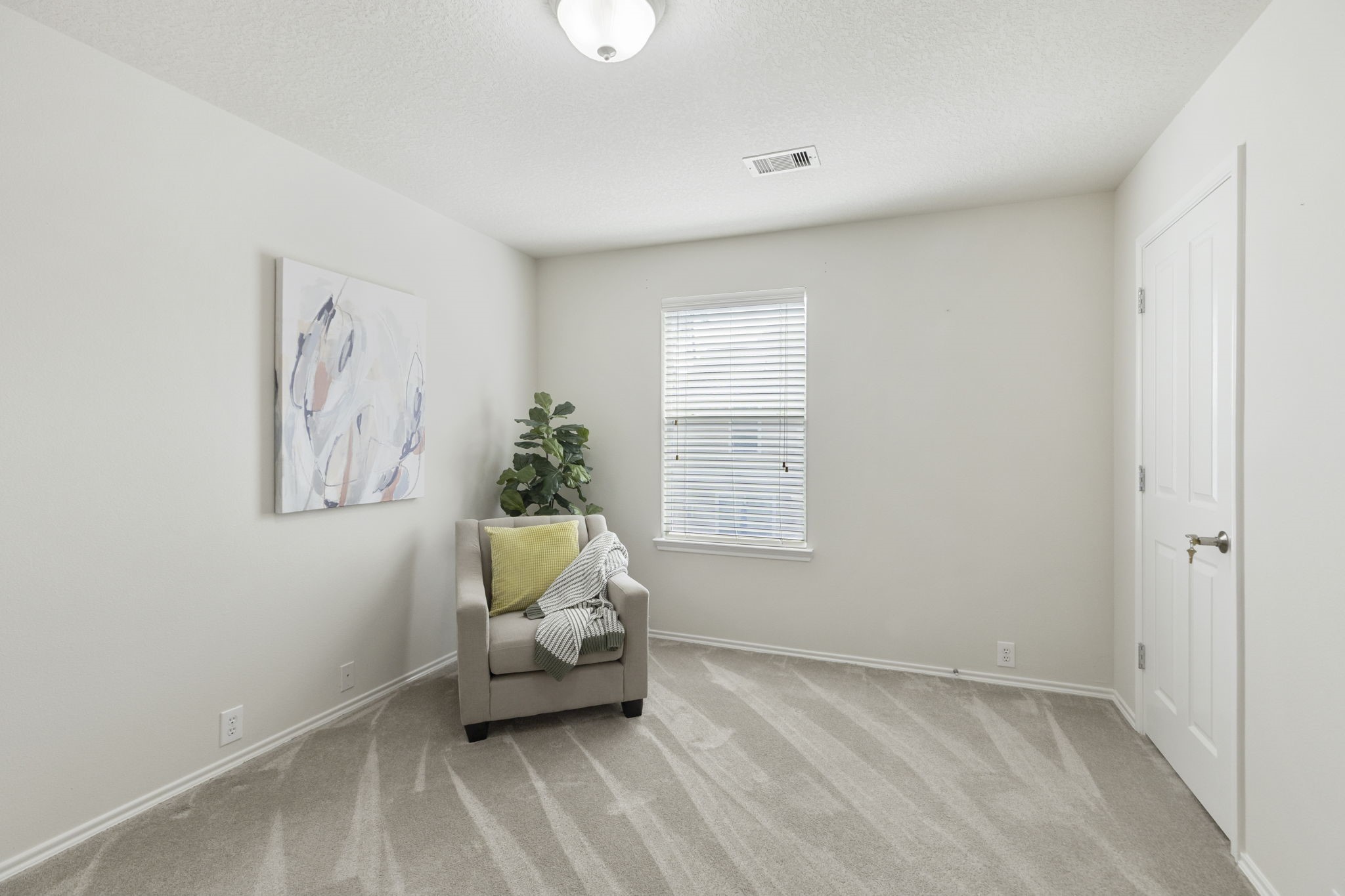 The secondary upstairs bedroom includes soft carpet, window and two closets.