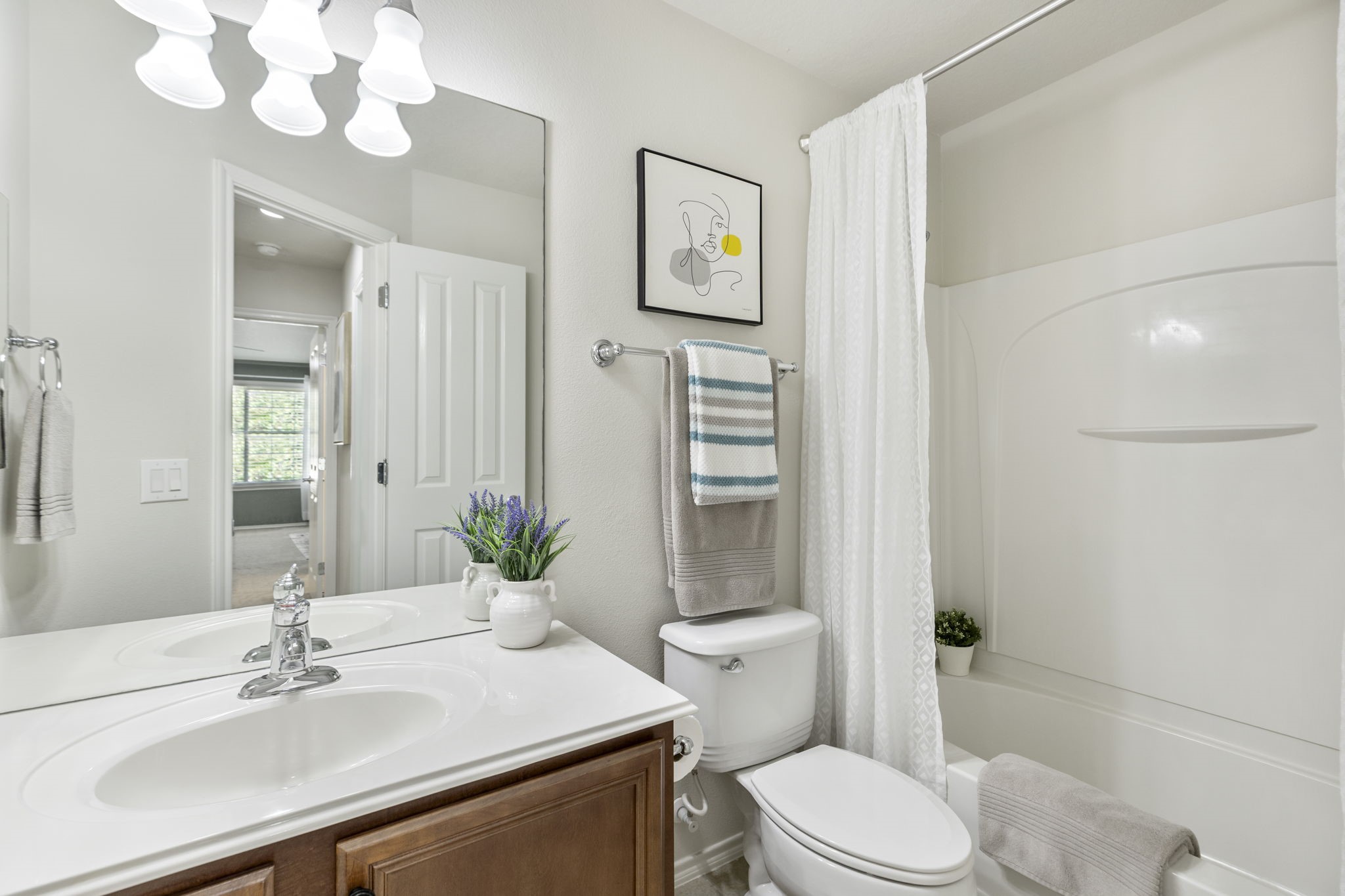 The inviting 2nd full bathroom features a vanity with seamless sink, cabinet storage and a tub / shower combination.