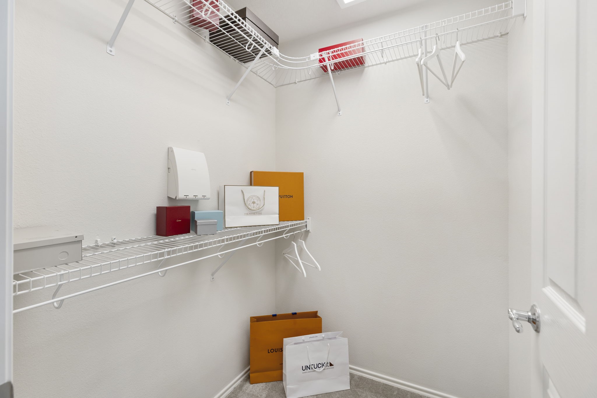 The walk-in closet offers ample shelving and hanging space to keep everything organized and neat.