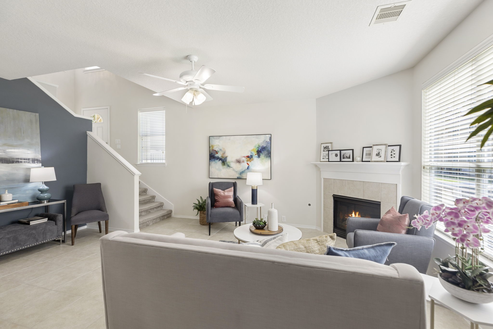 The living room is bathed in natural light and offers a view of the manicured green space. This is a perfect space for relaxing or entertaining.