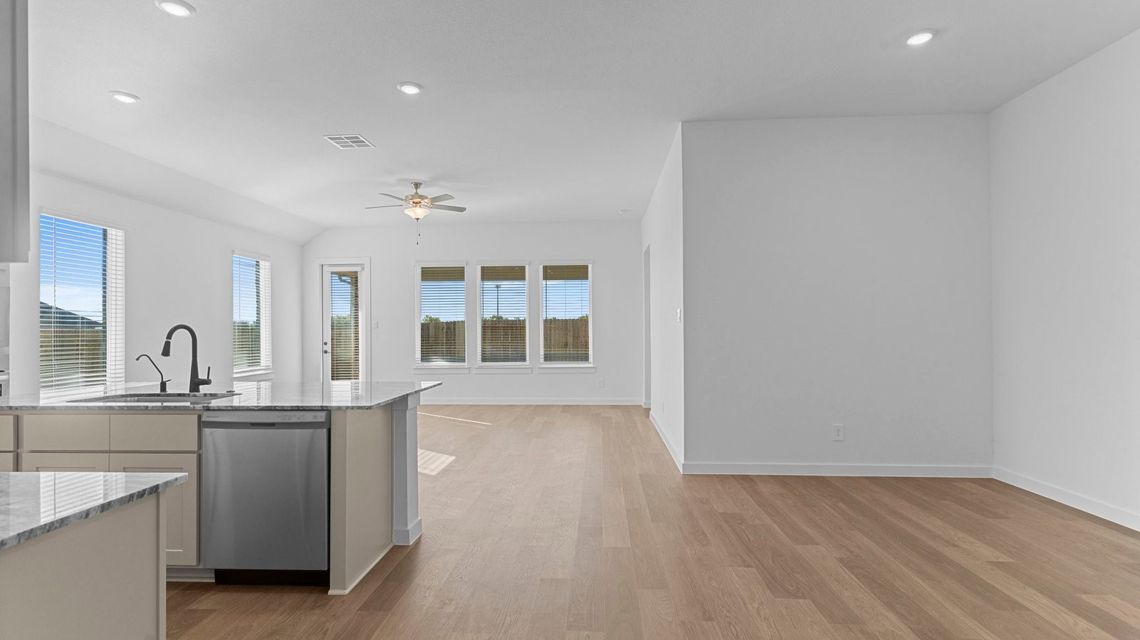 A well-organized living room that includes a kitchen and dining area, creating a warm and welcoming environment for gatherings.