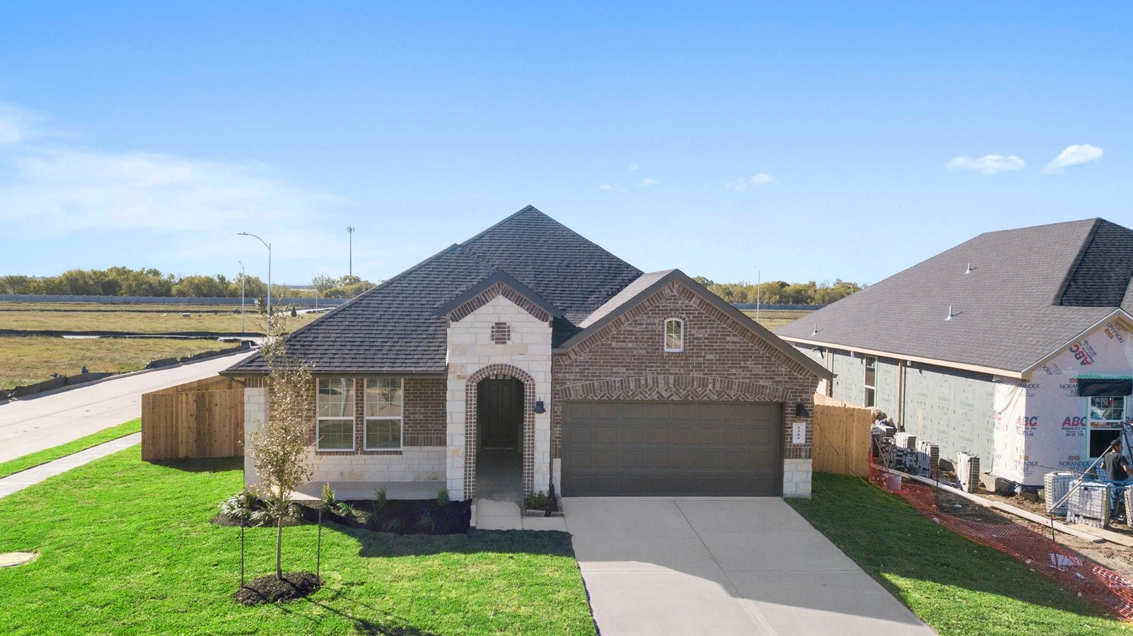 Newly built single story home with traditional architecture, a garage, and landscaped front yard. Newly built single story home with traditional architecture, a garage, and landscaped front yard.
