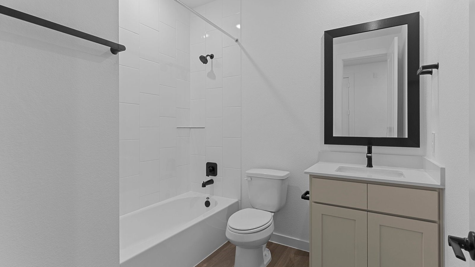 A well-designed bathroom equipped with quartz countertops, a standing tub, and a single vanity