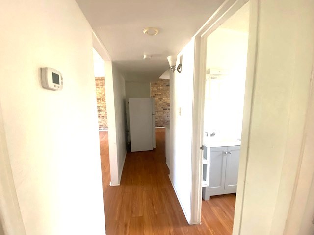 Hallway from bedrooms to hall bath, kitchen, and living room.