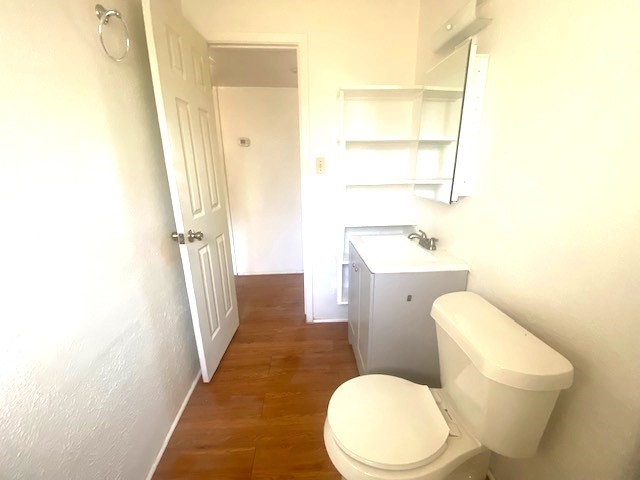 Another view of hall bath with extra shelving for storage.