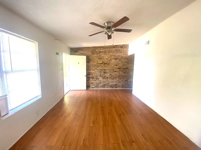 The living room has an accent brick wall.