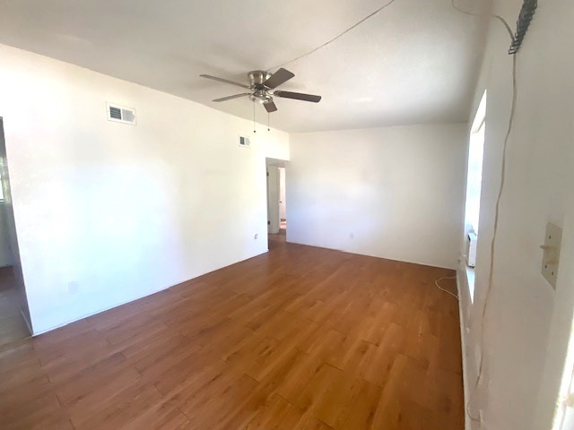 Spacious living rom with ceiling fan and laminate flooring throughout the entire unit. (no carpet)