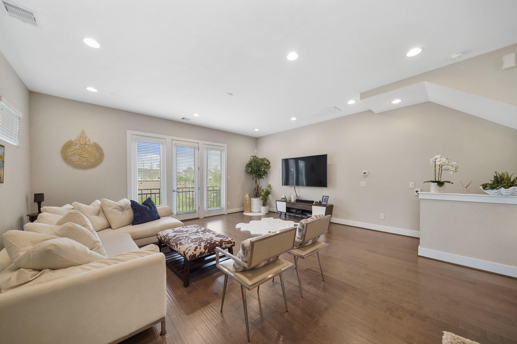 Windows and a glass door with blinds opens to a wrought iron balcony overlooking the front of the home. Included is pre-wiring for a wall mounted flat screen TV. Windows and a glass door with blinds opens to a wrought iron balcony overlooking the front of the home. Included is pre-wiring for a wall mounted flat screen TV.