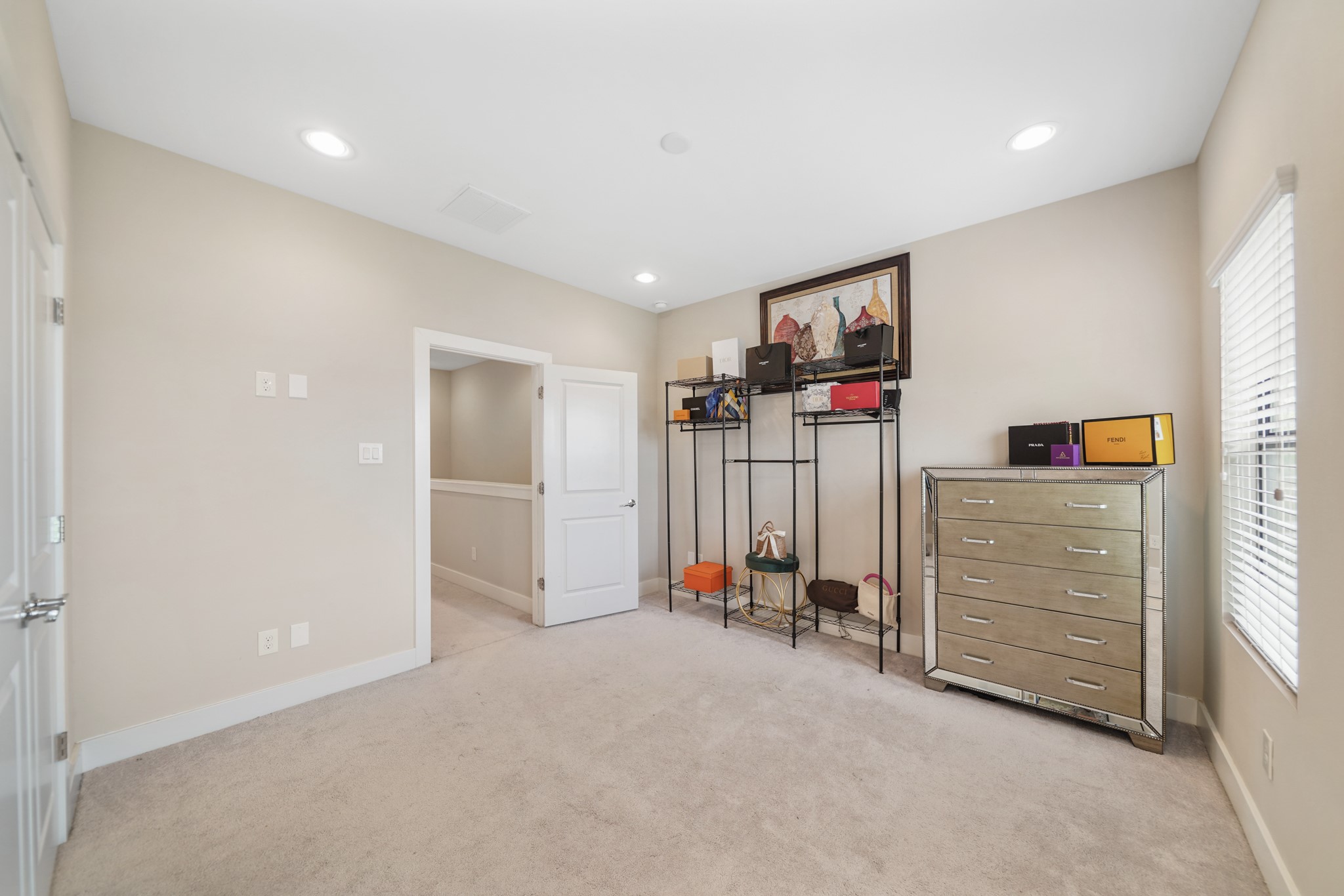 The second bedroom with an ensuite bath has recessed lighting, pre-wiring for a ceiling fan and carpet. The chest of
drawers can stay with the home.