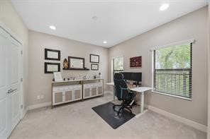 The third bedroom accessible from the foyer of the home has recessed lights, pre-wiring for a ceiling fan, two windows with blinds & carpet.