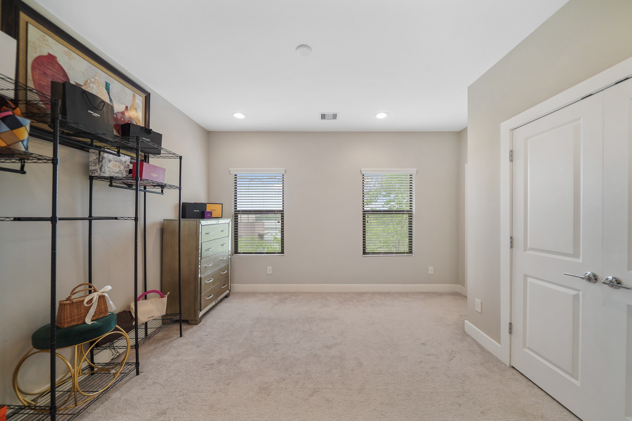 Included are two windows with blinds overlooking the side of the home along with a double door wardrobe storage closet.