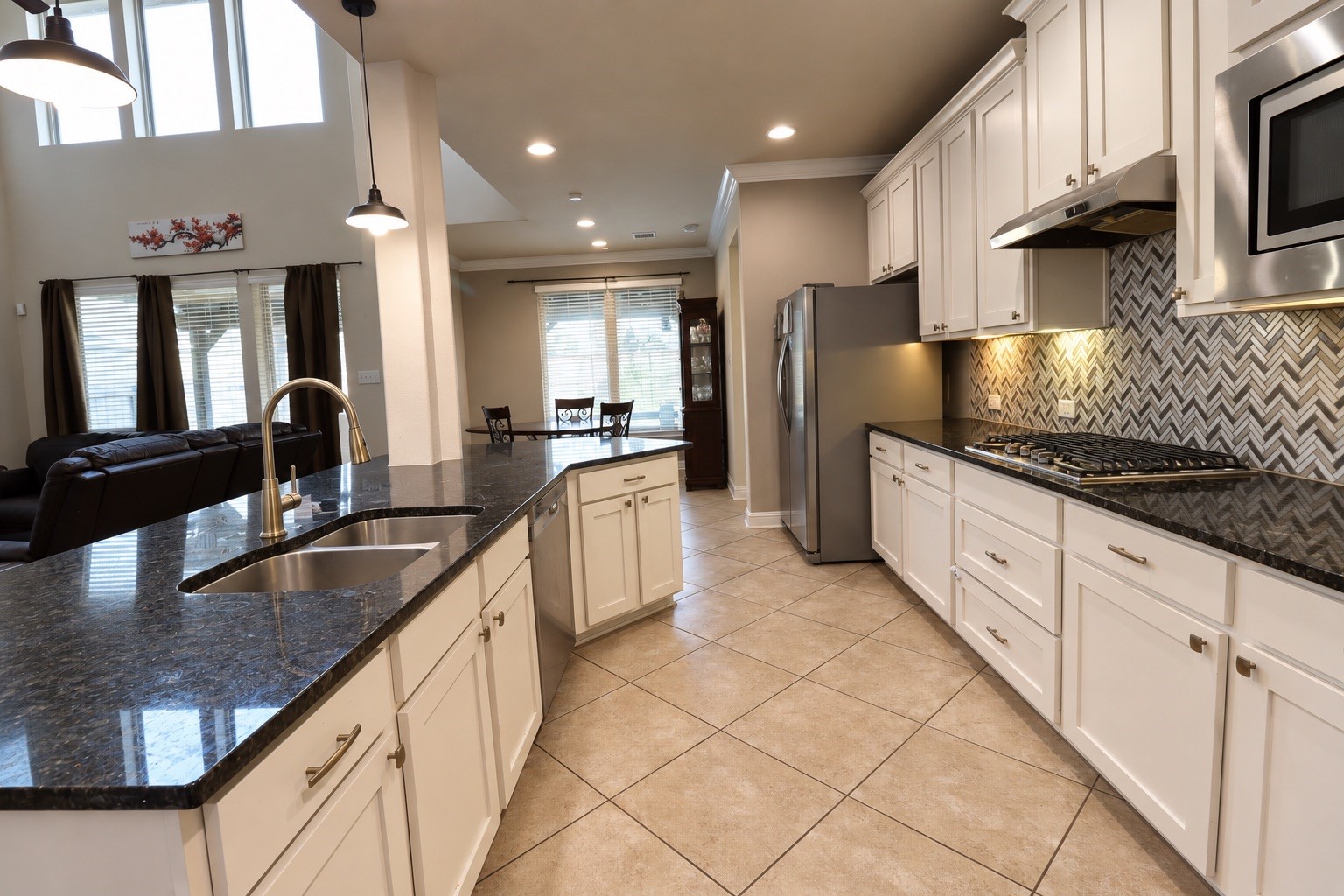 Garmet Kitchen equipped with double ovens and large counter island