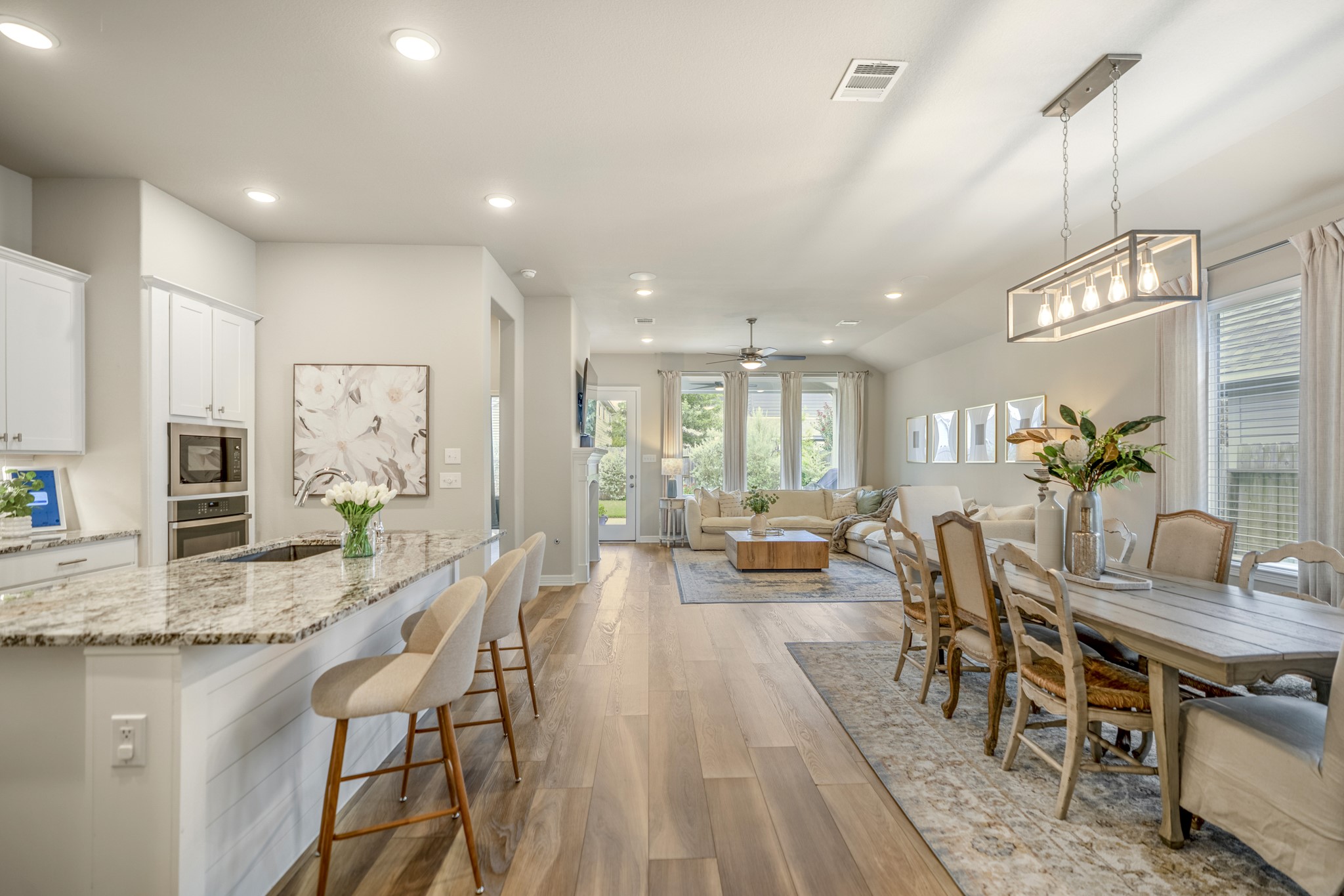 Gorgeous sightline and flow! Floor to ceiling windows allow natural light in as well as those lush landscaping views.