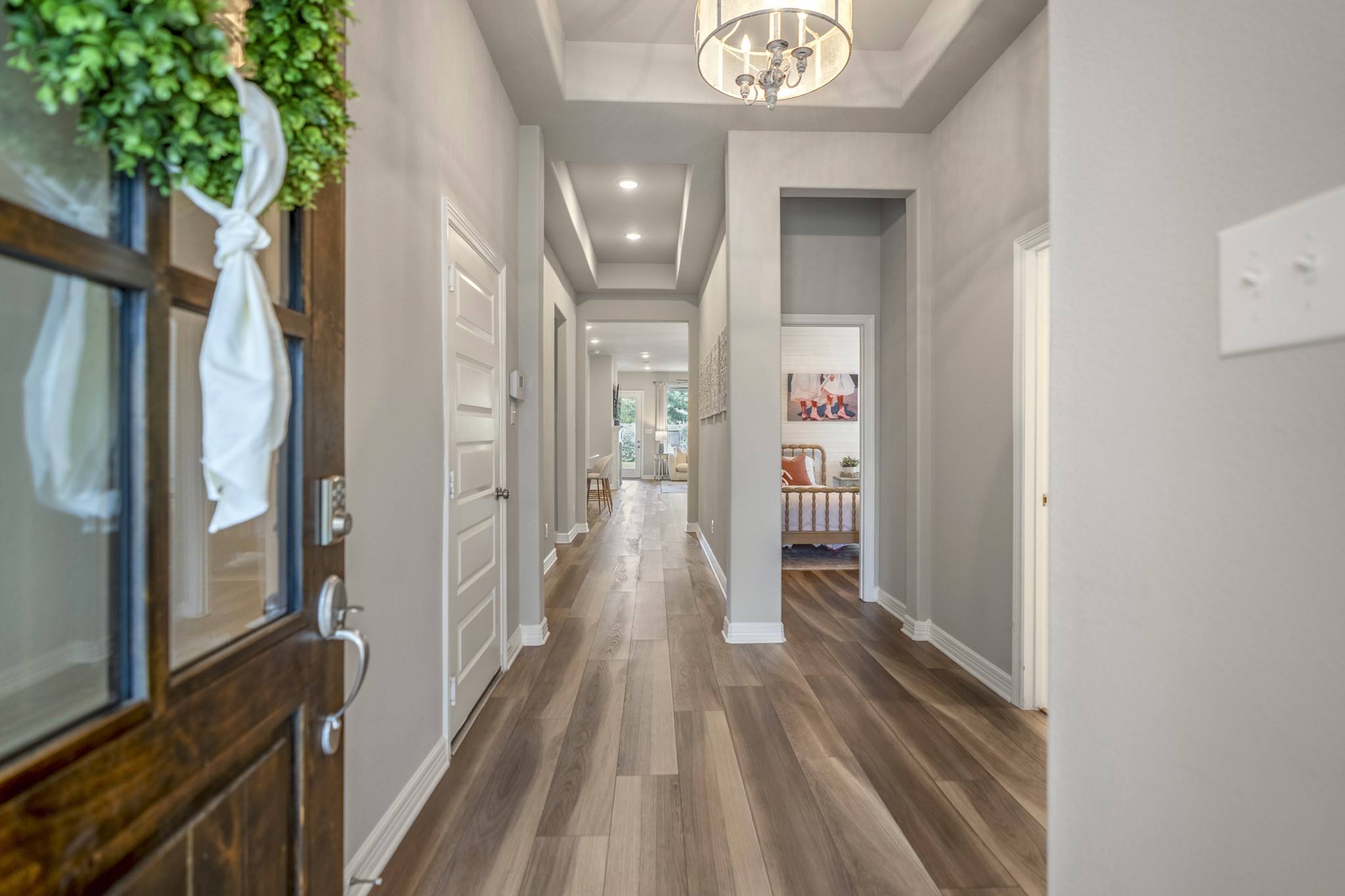 It's all in the details of this home. Front to back sightline is highlighted with the tray ceilings, lvp flooring throughout and timeless neutral color palette.