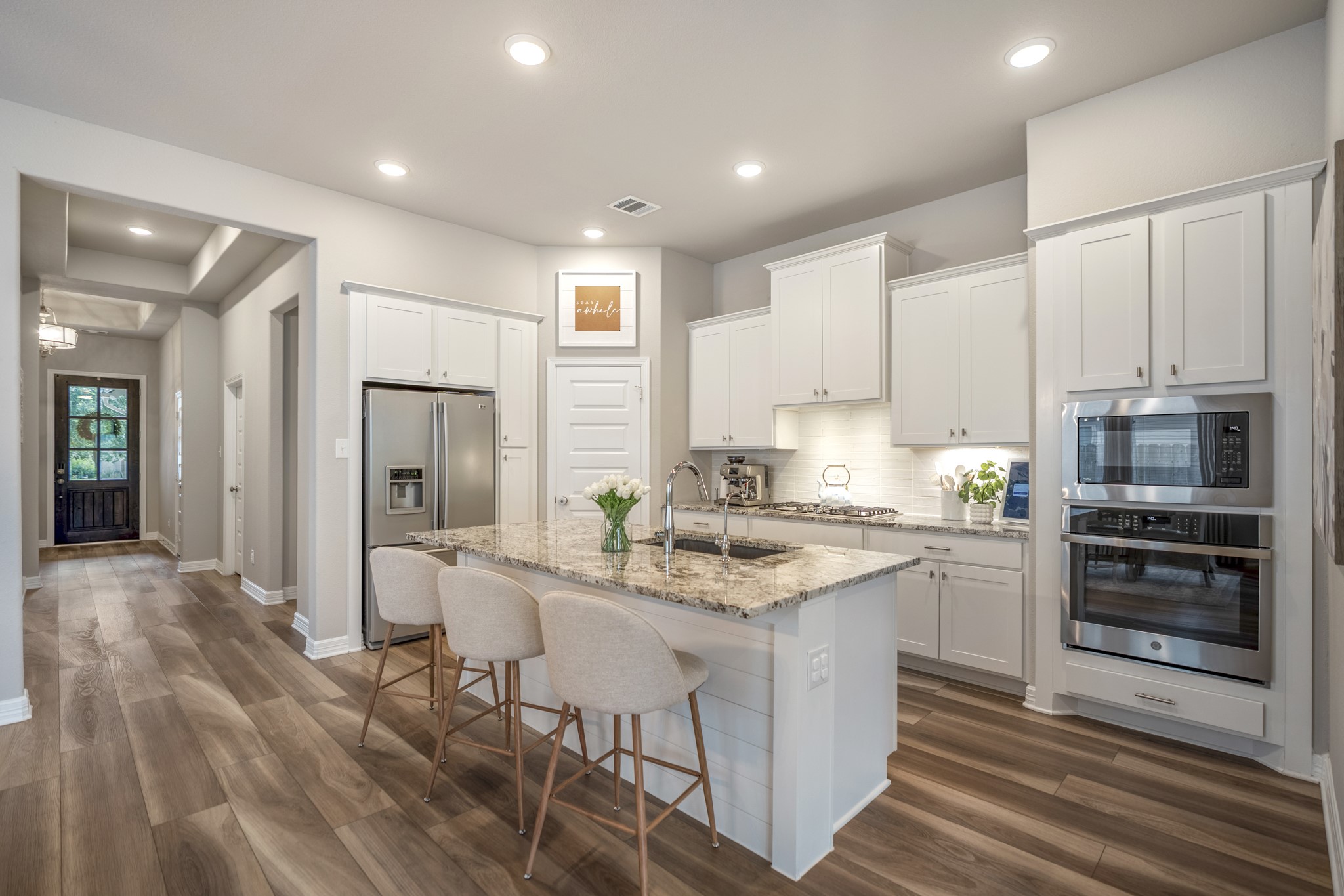 Gourmet kitchen with classic white shaker cabinets, timeless granite countertops, walk-in pantry and a fantastic flow. Love the bonus cabinet near refrigerator!