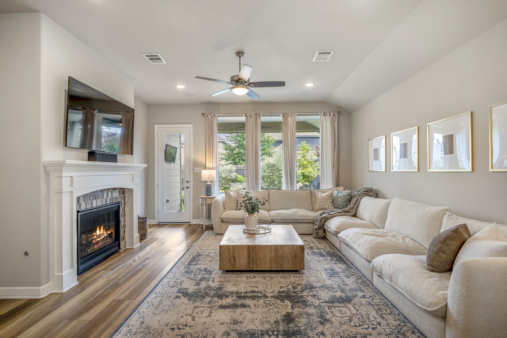 Living room includes built-in surround sound and beautiful mosaic tiled fireplace.