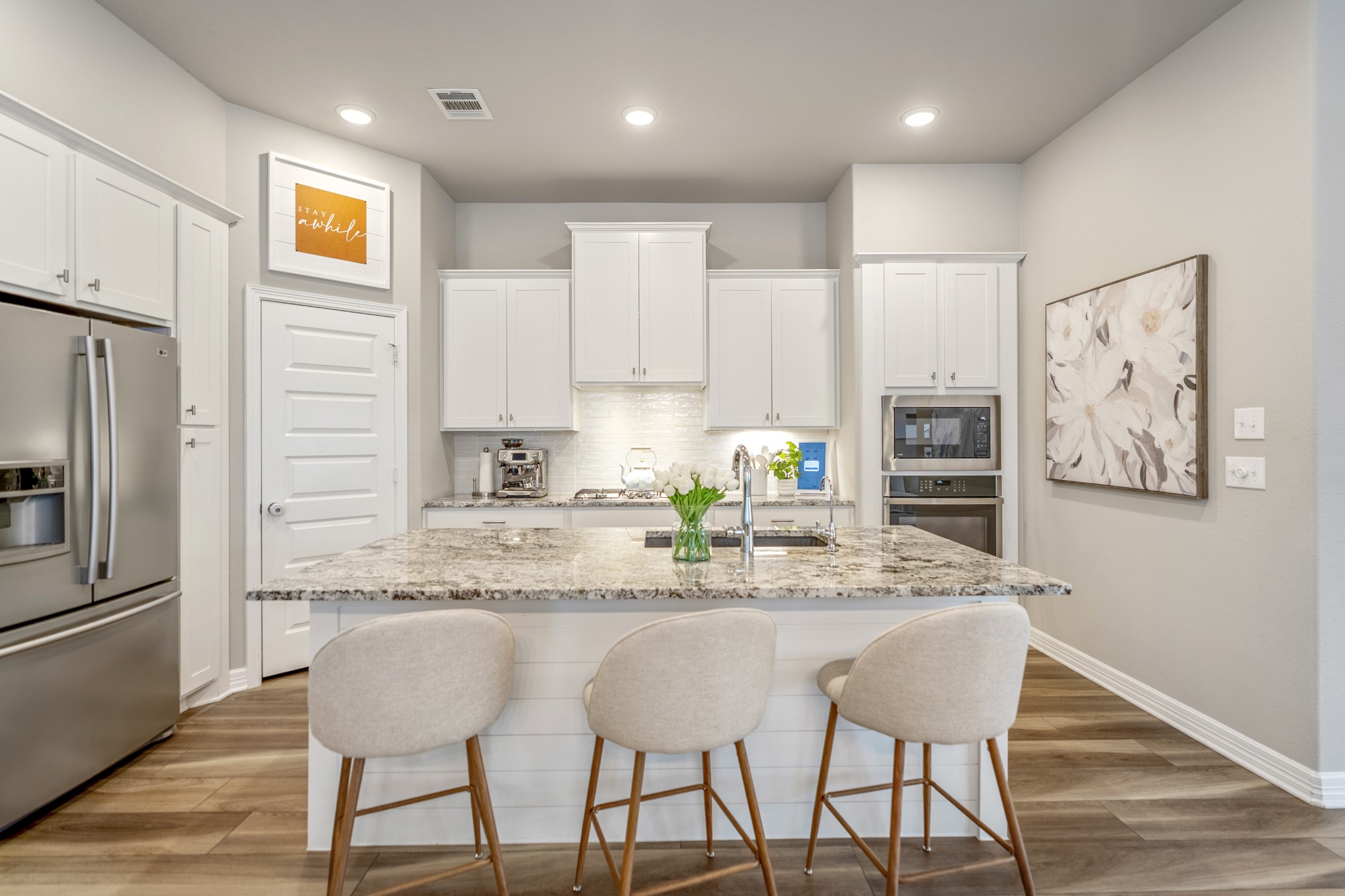 Kitchen features under cabinet lighting and counter seating.