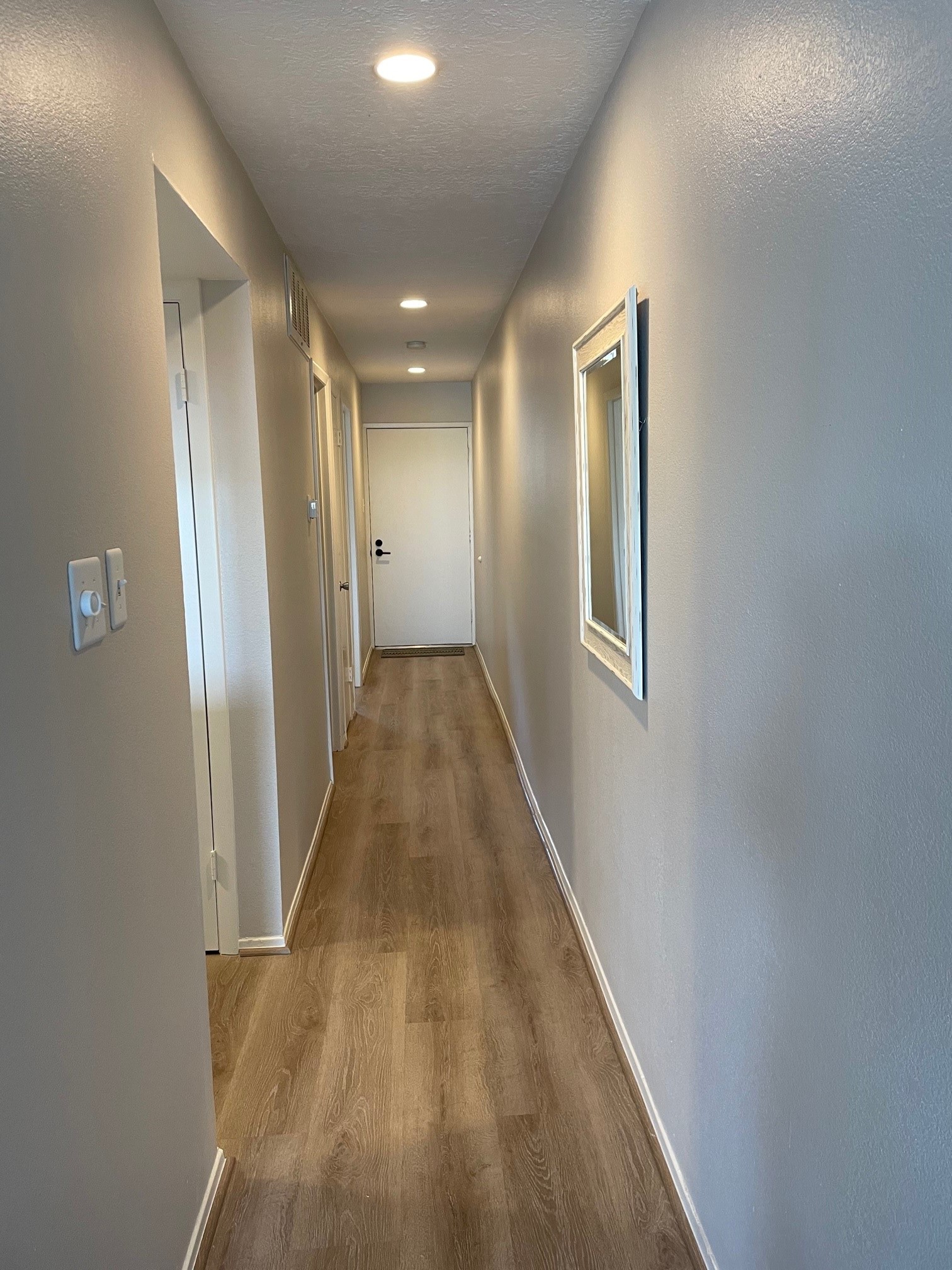 Beautiful recessed lighting in hallway and living area. Extra storage in the hall closet.