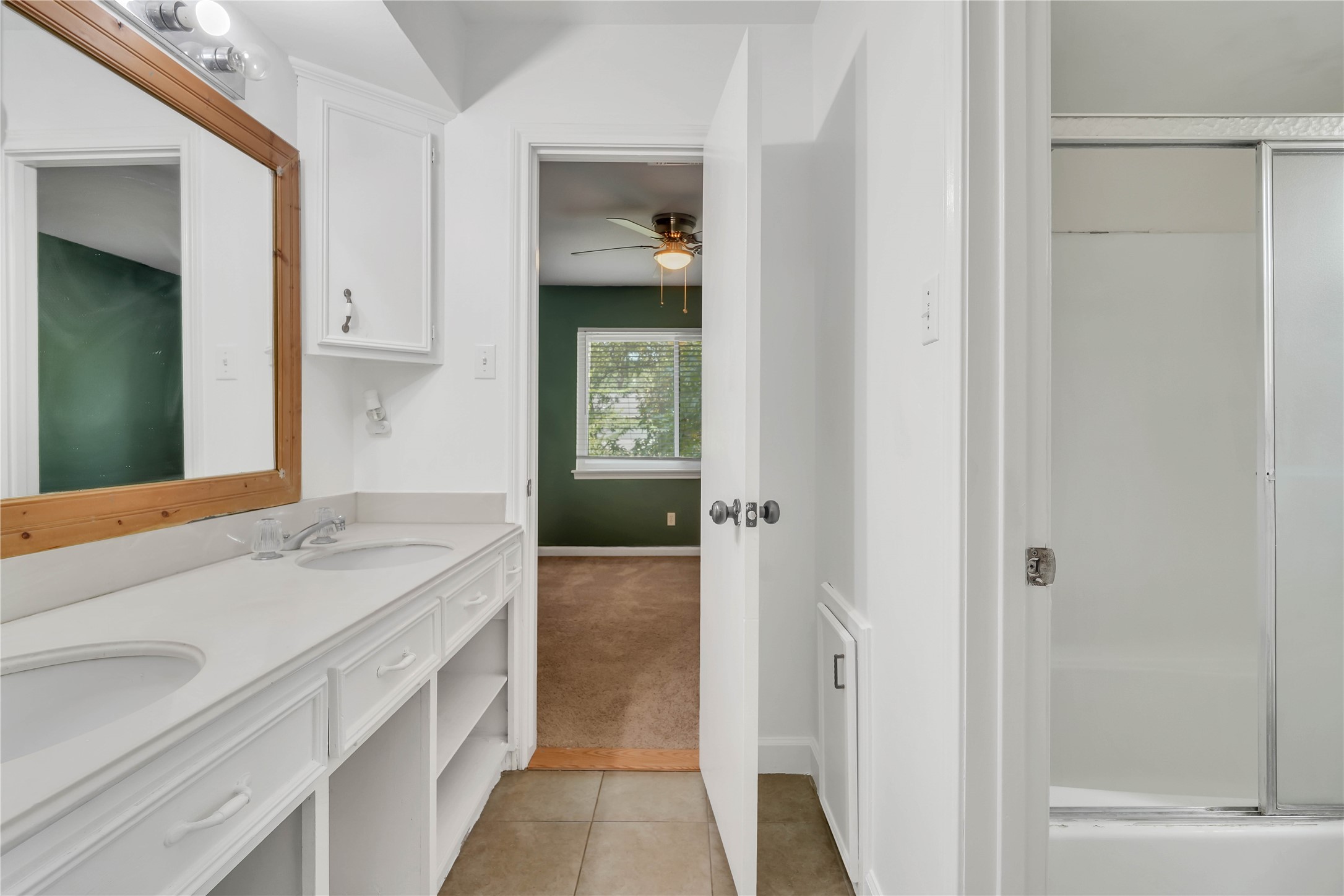 Upstairs Jack-and-Jill bathroom conveniently connecting two secondary bedrooms, featuring an extended vanity with ample counter space and storage.