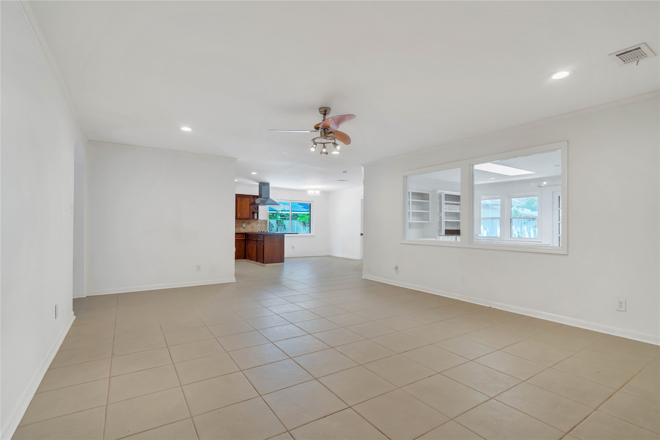 Open-concept living area offering generous space for multiple seating arrangements, with abundant natural light and seamless flow into the adjoining areas.