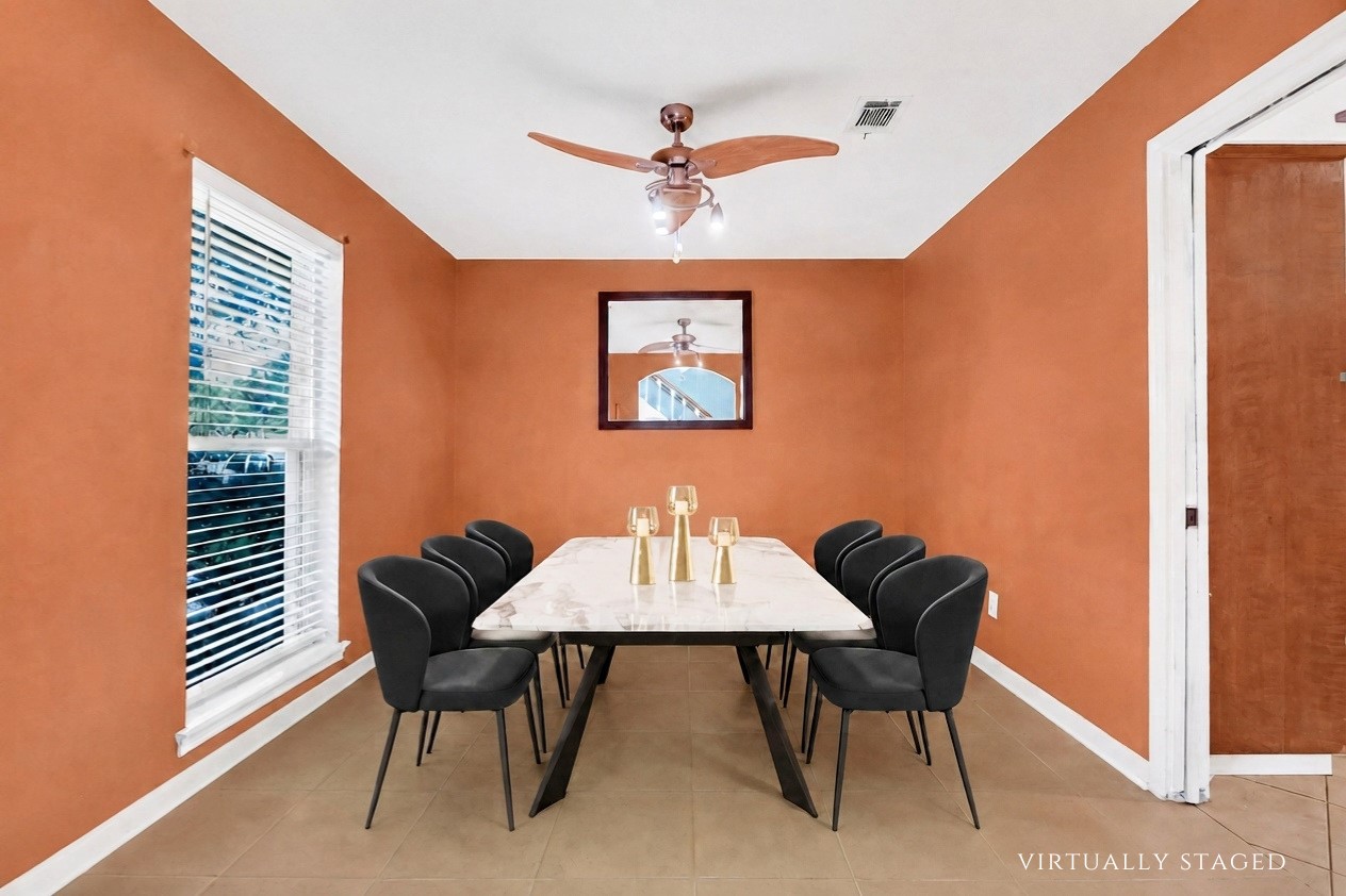 Virtually staged to showcase the generous scale of the formal dining room, comfortably accommodating a six-seat dining table with ample room for entertaining.