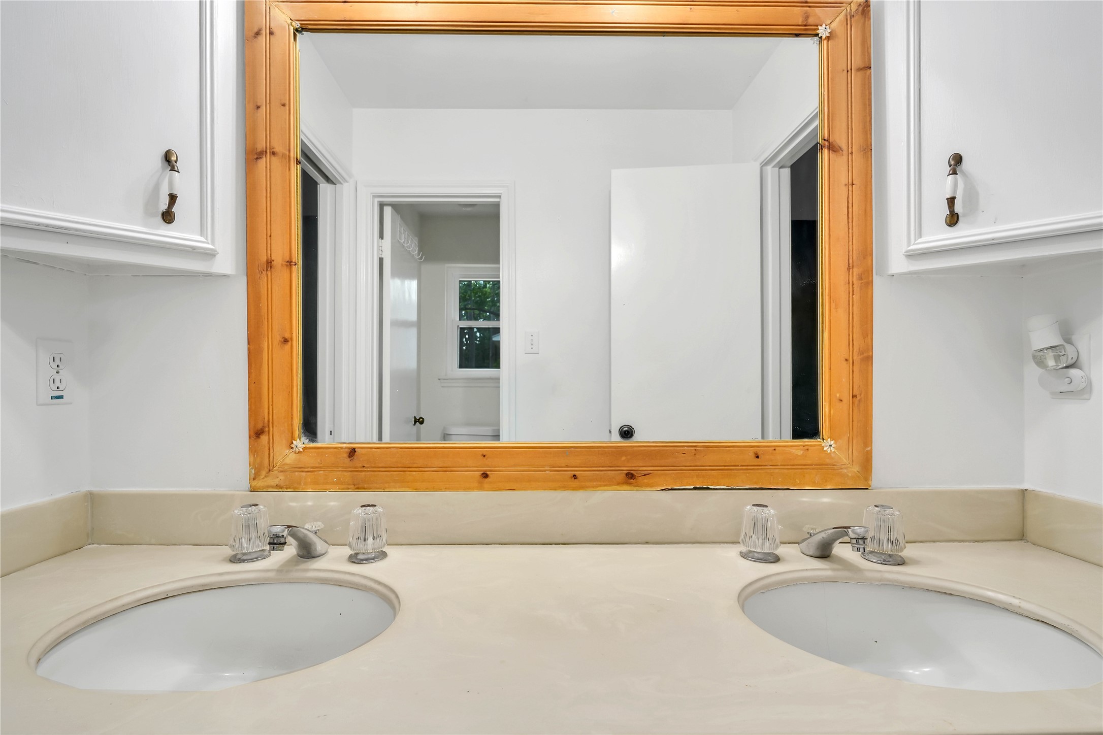 Dual-sink vanity provides each adjoining bedroom with dedicated space, complemented by generous counter space and cabinetry.