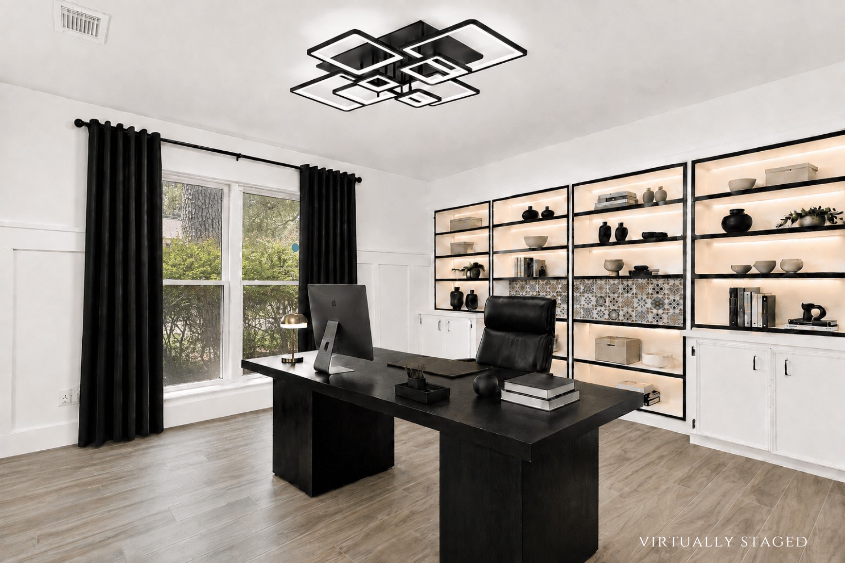 Virtually staged to showcase the impressive scale of this downstairs office, with ample room for a substantial executive desk complemented by the extensive built-in shelving and cabinetry.
