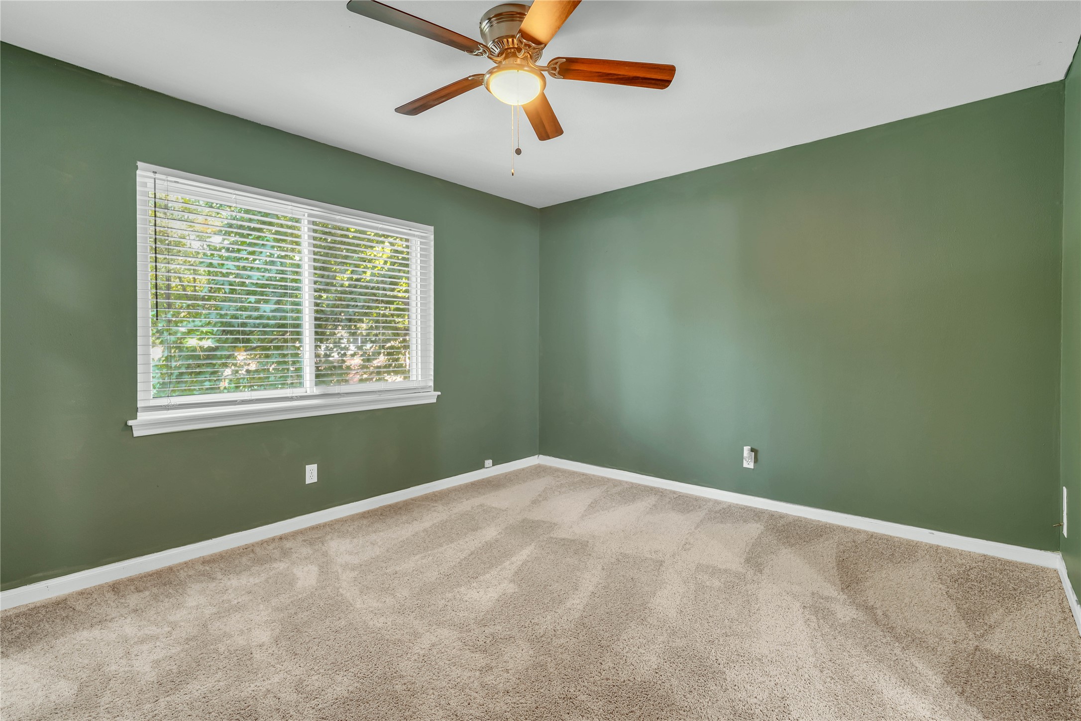 Spacious upstairs bedroom with abundant natural light and direct access to a Jack-and-Jill bathroom.