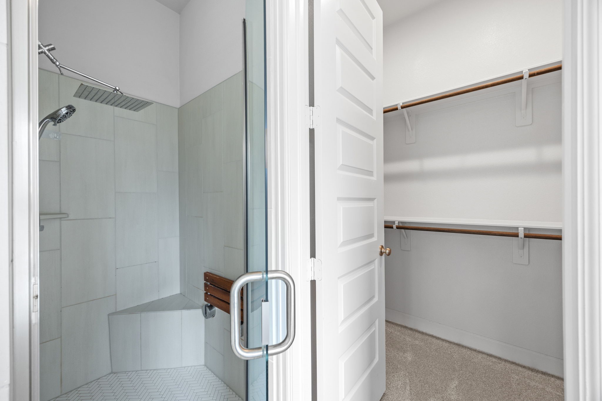 Beautifully appointed bathroom featuring a glass-enclosed shower and convenient built-in shelving.