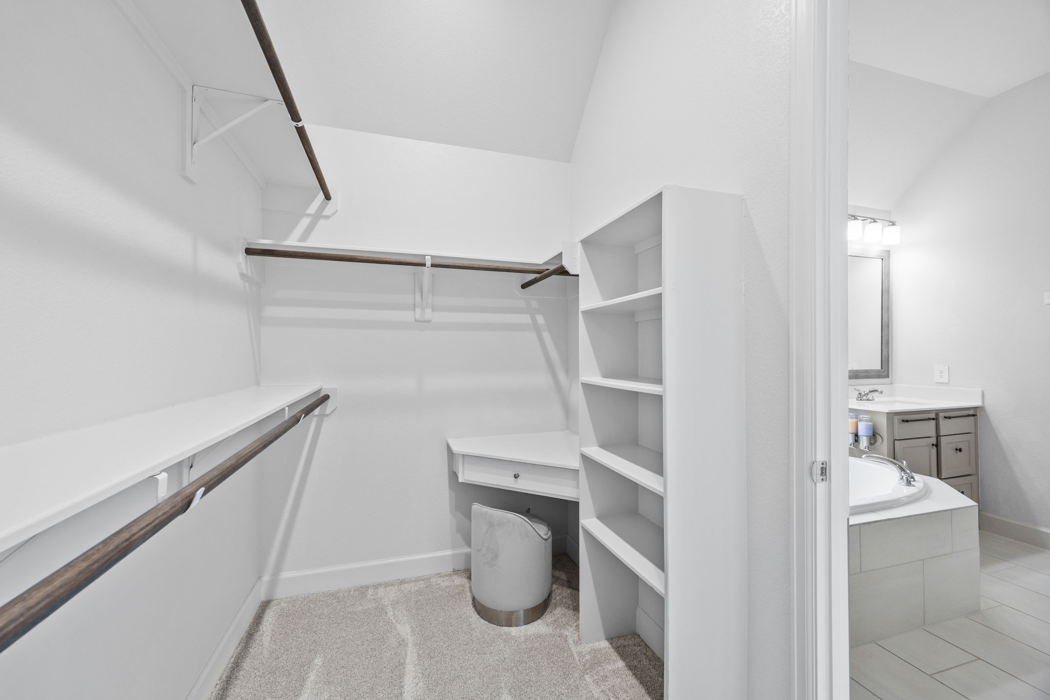 Expansive walk-in closet featuring built-in shelving, hanging space, and thoughtful organization.