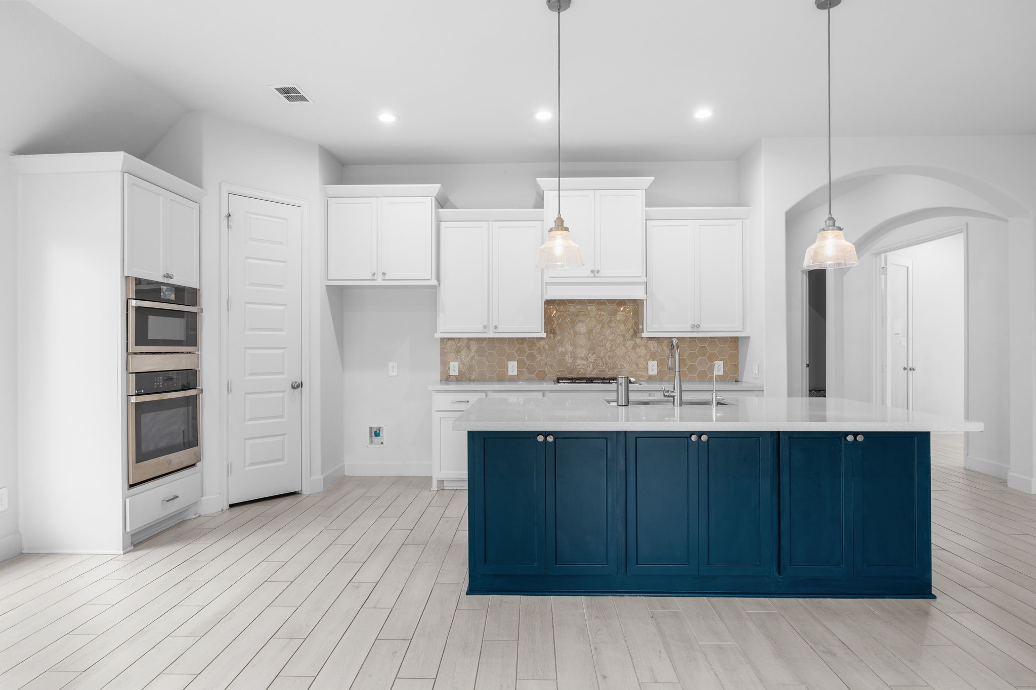 Gorgeous kitchen featuring a statement island, stainless steel appliances, and generous workspace.