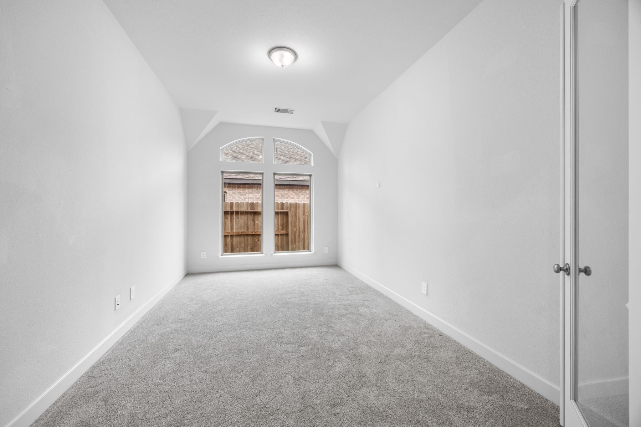 Bright, comfortable bedroom with a large window and plenty of room to make the space your own.