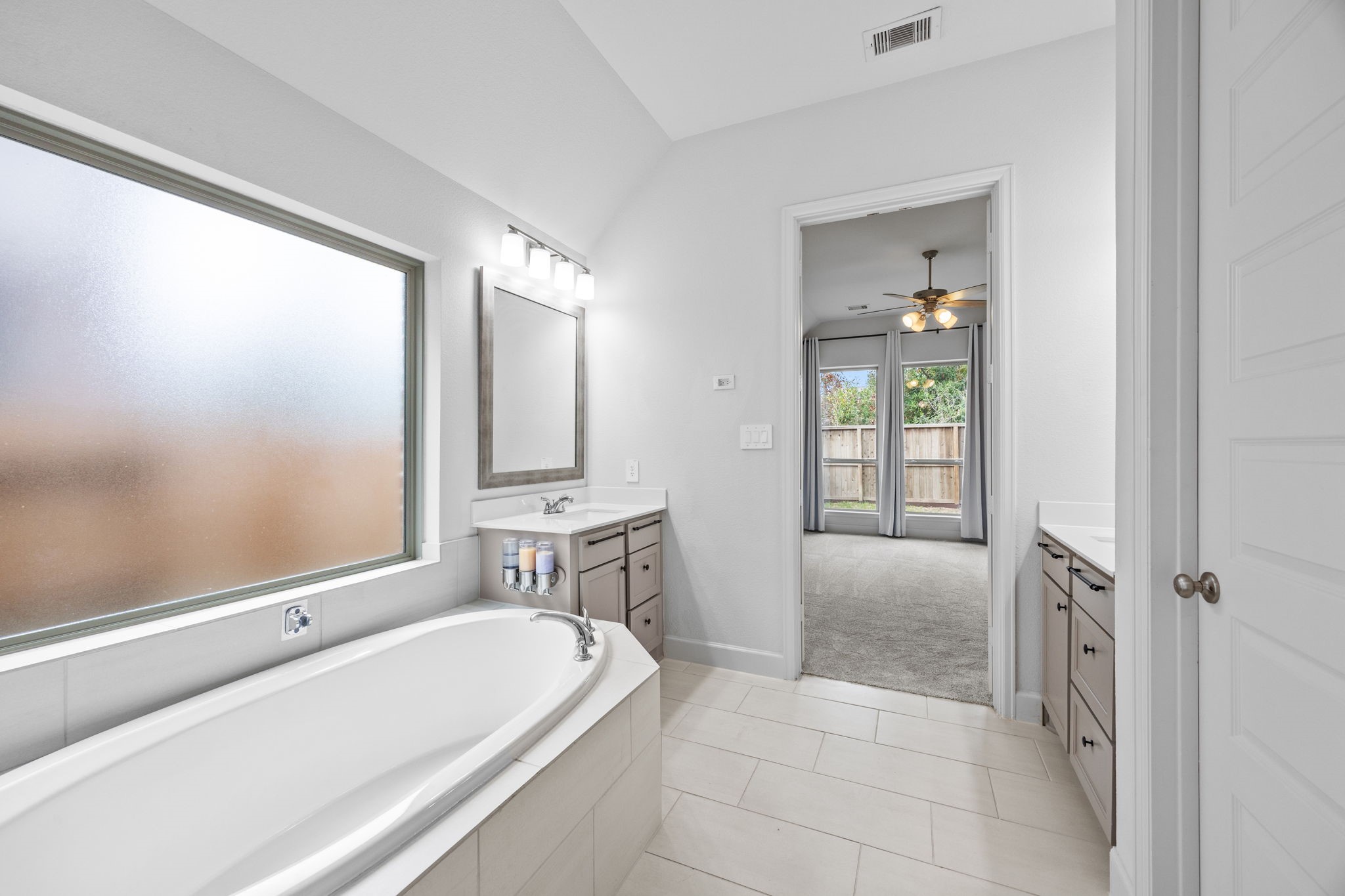 Spa-inspired bathroom with a luxurious soaking tub, abundant natural light, and elegant finishes.