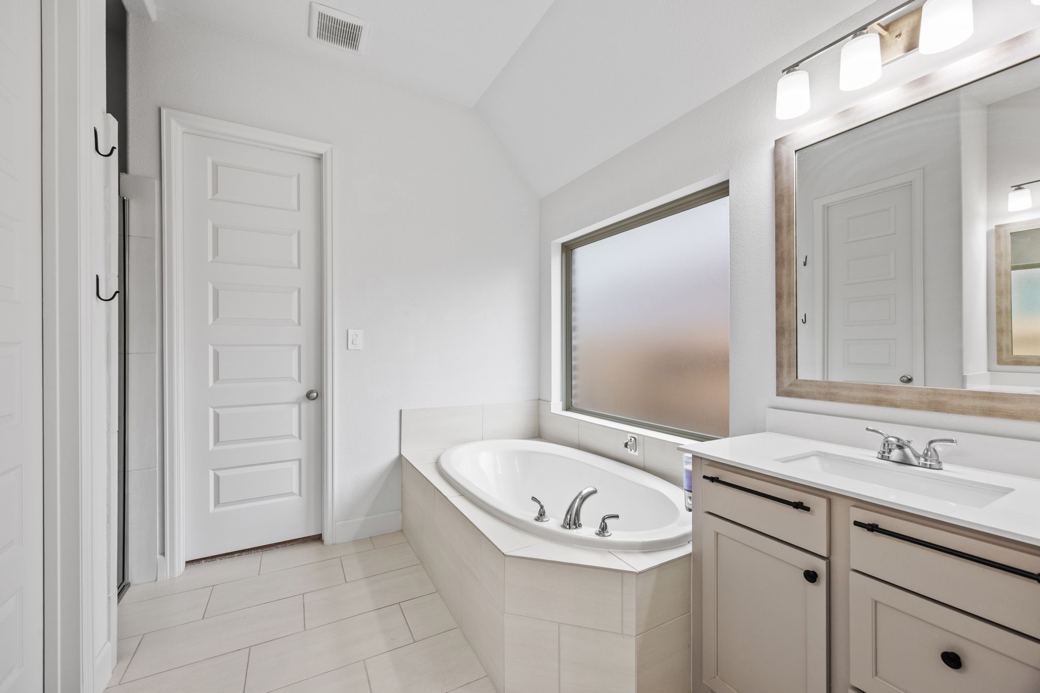 Relaxing bathroom retreat with a soaking tub, dual-sink vanity, and timeless finishes.